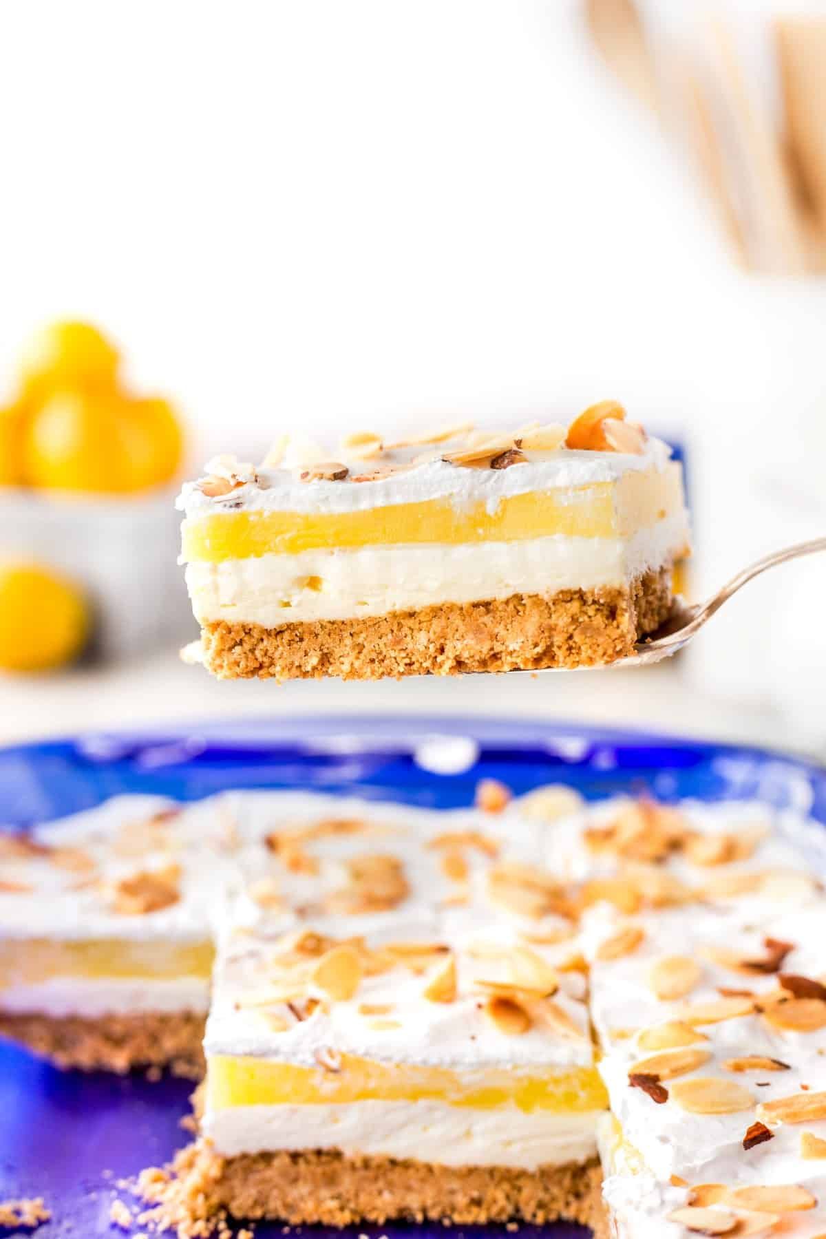 Slice of lemon lush dessert on a spatula.