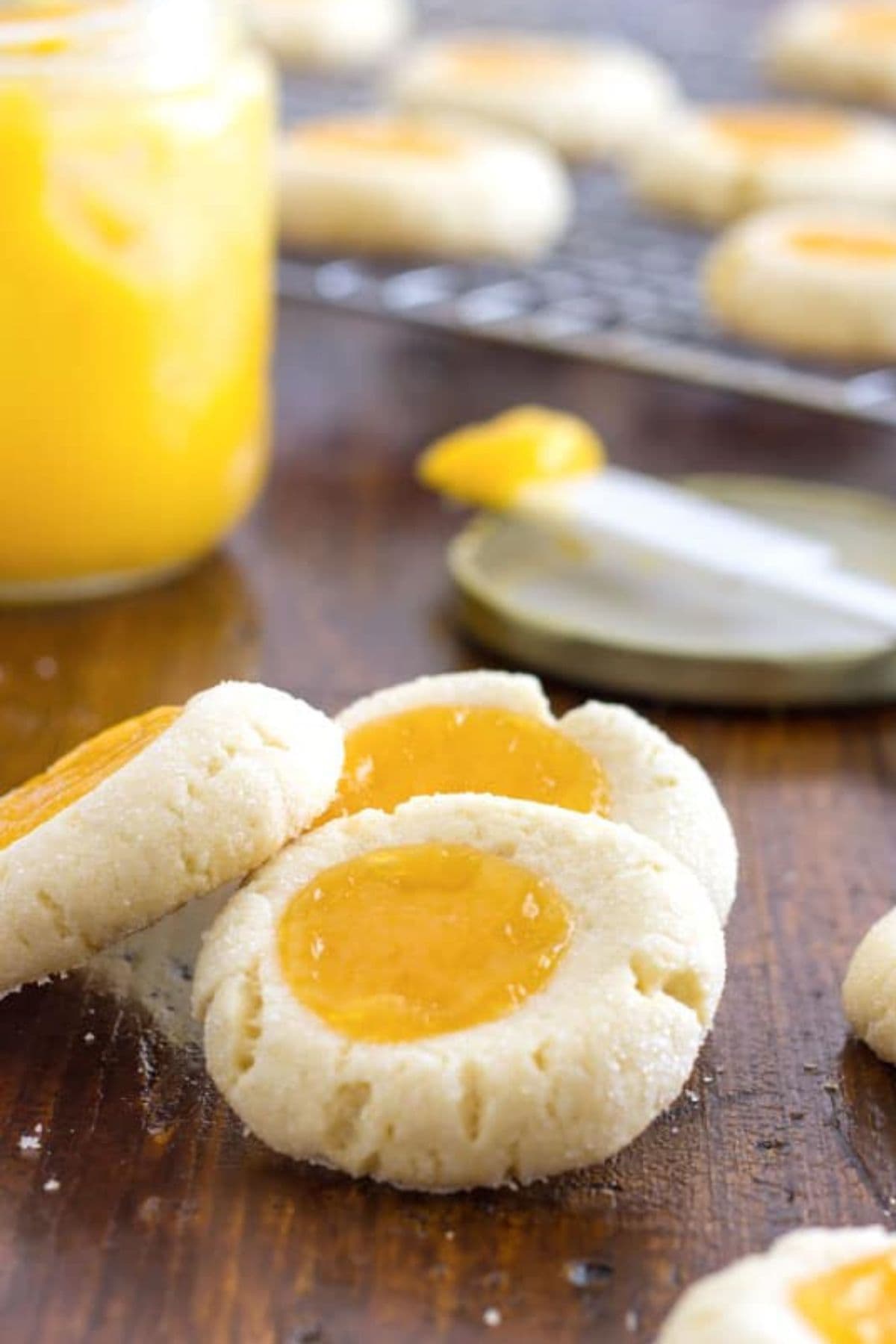 Lemon thumbprint cookies on cutting board.