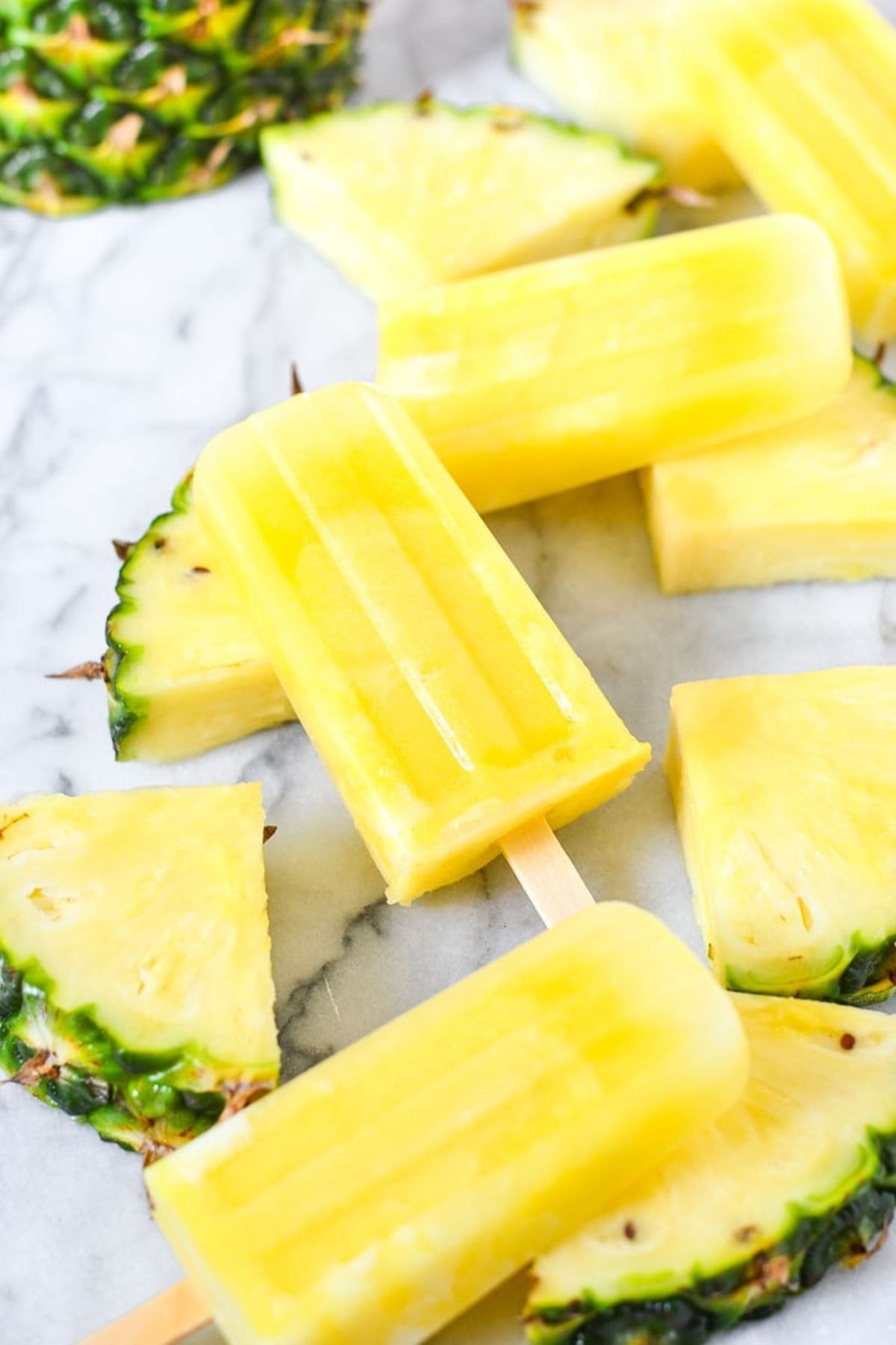 Pineapple popsicles on a counter.