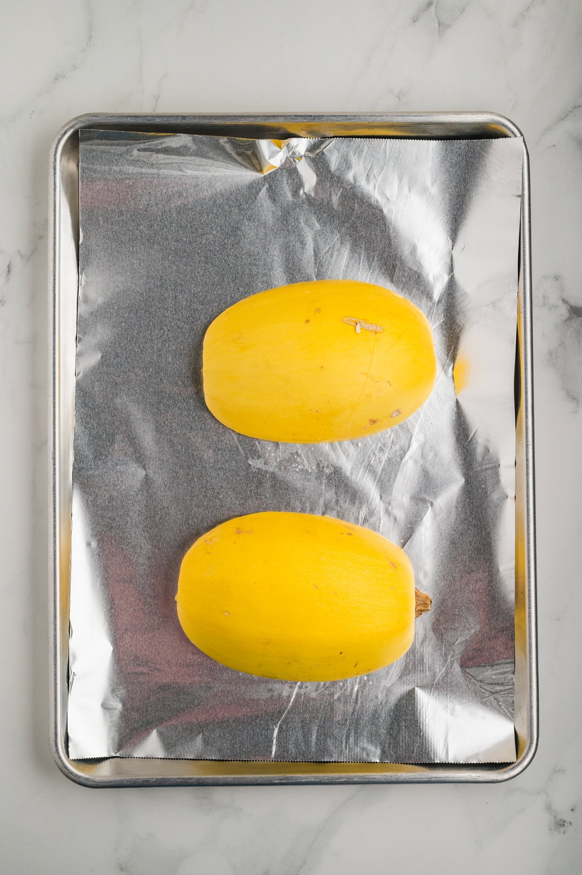 Squash skin side down on a baking sheet. 