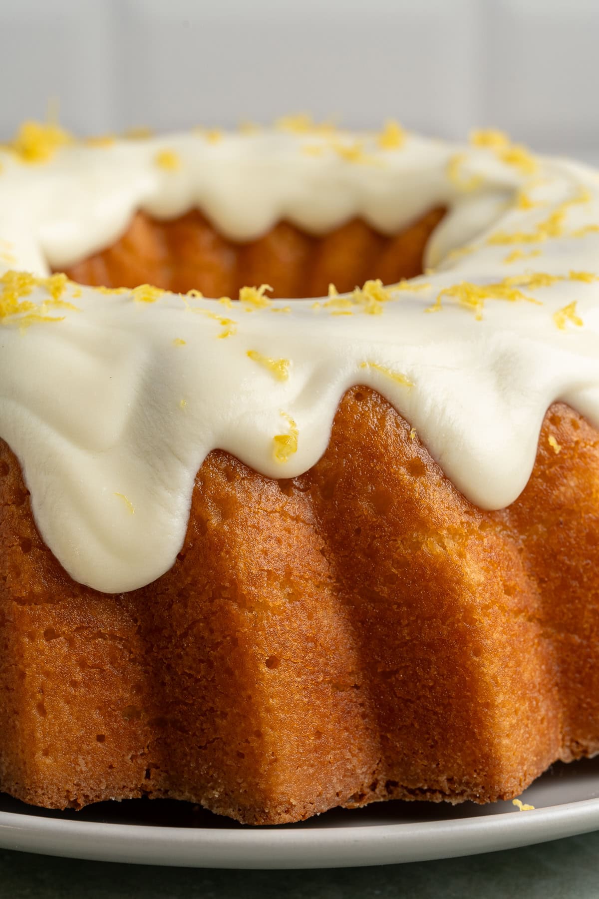 This Limoncello Cake is filled with luscious ingredients like lemon juice, lemon zest and limoncello to give you a lovely citrus flavor to this rich and butter cake. Close-up of a Limoncello Cake.