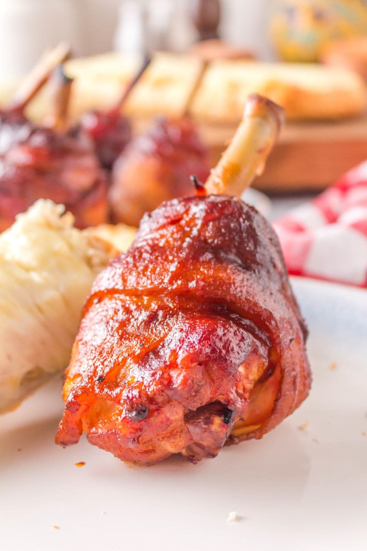BBQ chicken lollipop on a plate.
