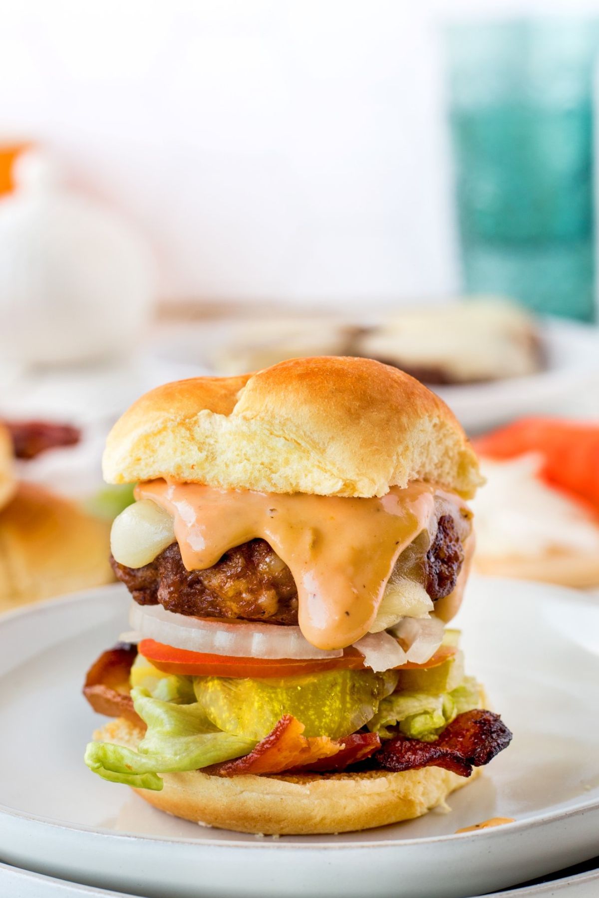 Beef sausage slider on a white plate.