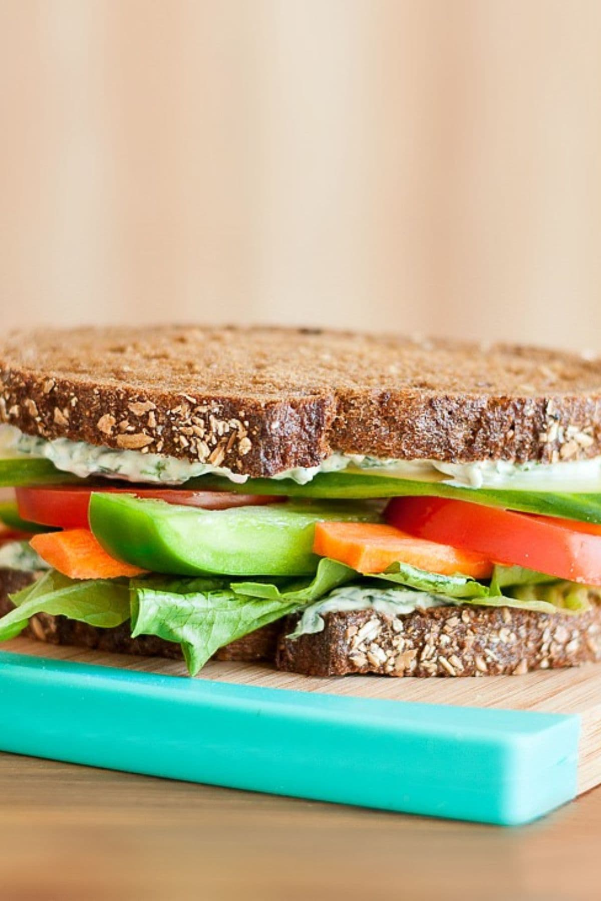 Get outside and enjoy the day with these 50 Picnic Basket Essentials. There is something for everyone to pack the perfect picnic and enjoy family time and the great outdoors. Sandwich on a cutting board.