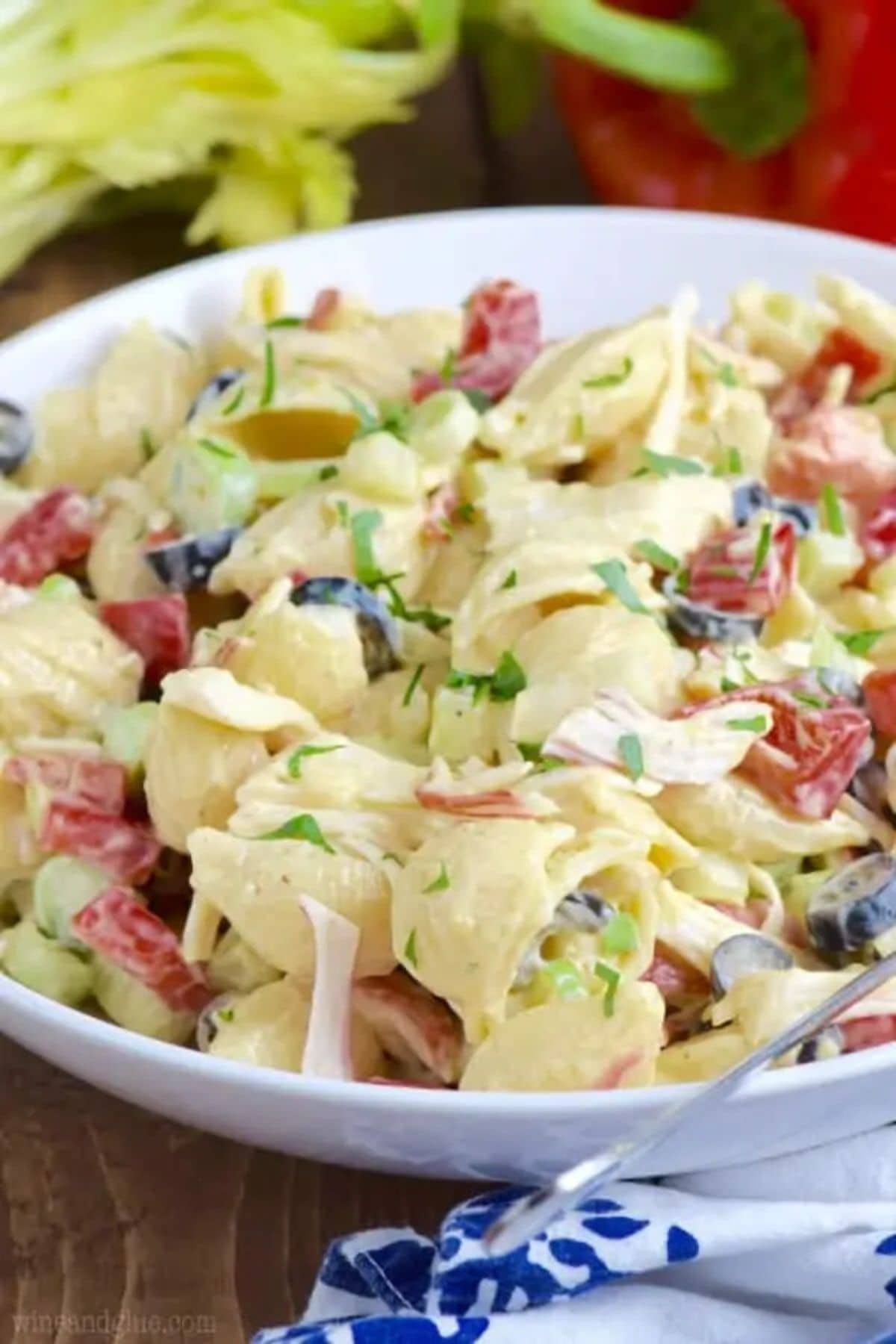 Get outside and enjoy the day with these 50 Picnic Basket Essentials. There is something for everyone to pack the perfect picnic and enjoy family time and the great outdoors. Crab pasta salad in a white bowl.
