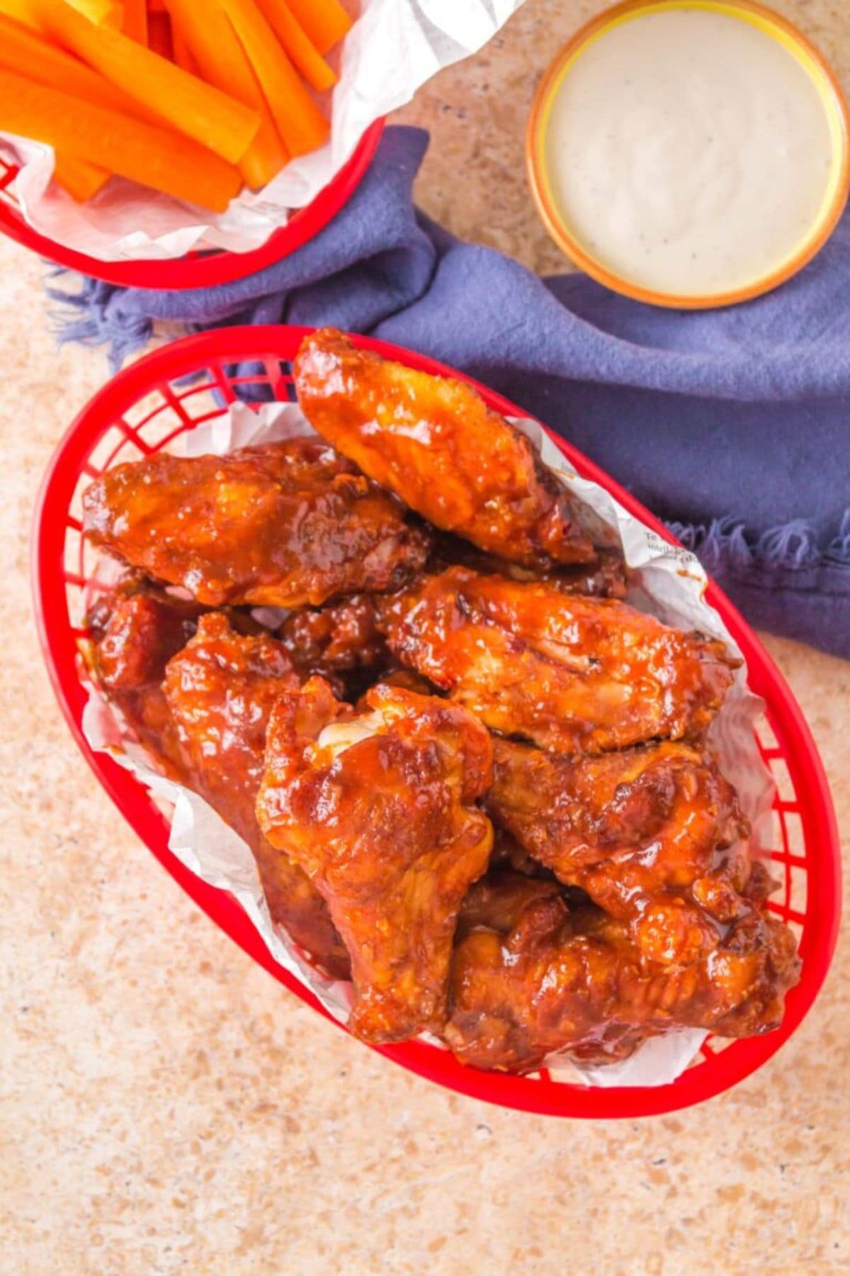 BBQ wings in a plastic basket.