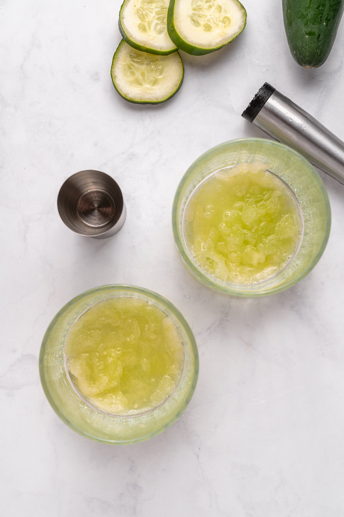 Vodka Cucumber Cocktail is the perfect summer porch sipper on a hot day!! It is easy enough to make for yourself, but perfect for any gathering or BBQ! Your company will rave over it. Muddling cucumber and melon.