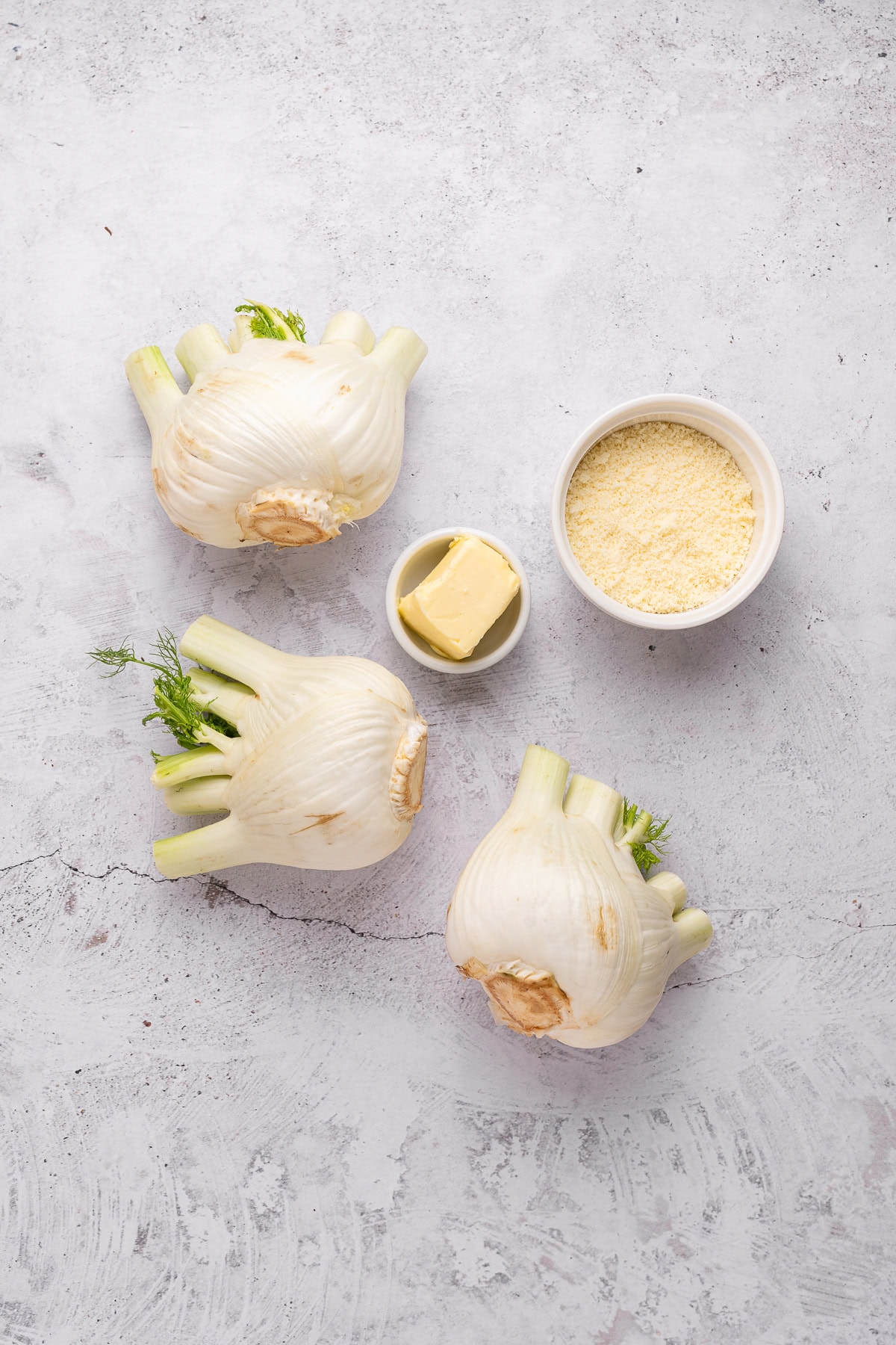 This recipe for Baked Fennel With Parmesan Cheese is unique and delicious. Baking fennel makes it mellow, and the butter and cheese make it excellent. Baked Fennel ingredients.