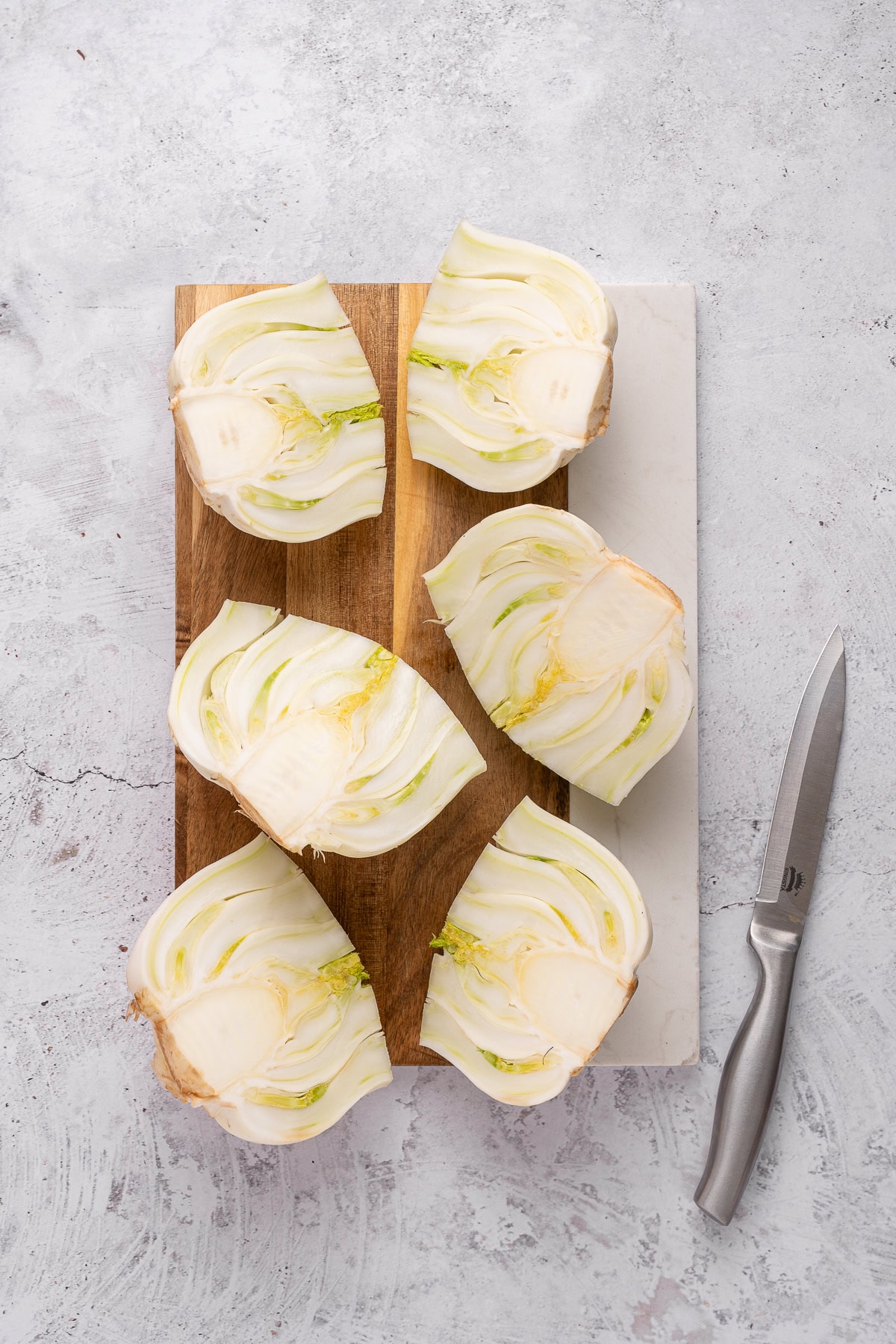 This recipe for Baked Fennel With Parmesan Cheese is unique and delicious. Baking fennel makes it mellow, and the butter and cheese make it excellent. Halved fennel bulbs.