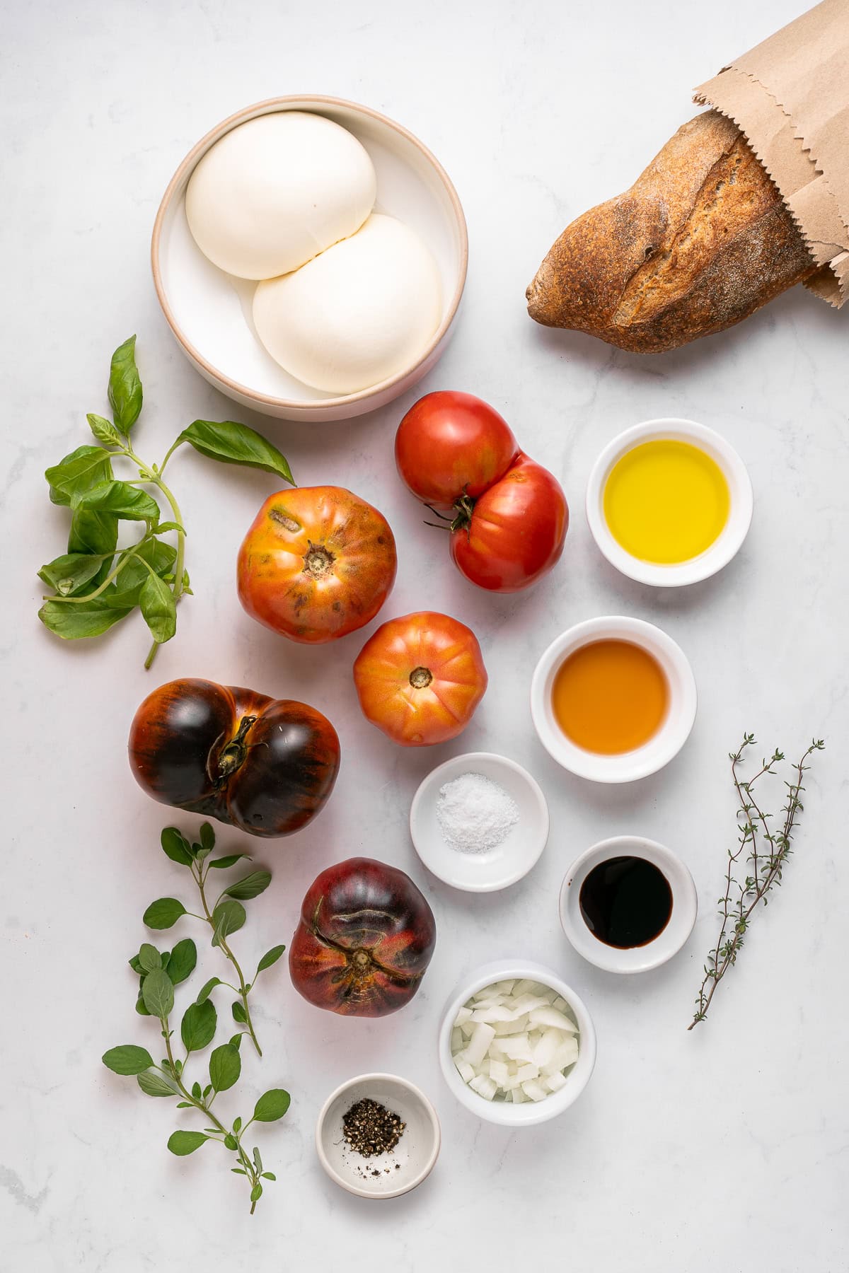 A Tomato Burrata Salad like this can be a show-stopper for any get-together. Use fresh heirloom tomatoes if available. They are the best with the creamy burrata. Tomato burrata salad ingredients.