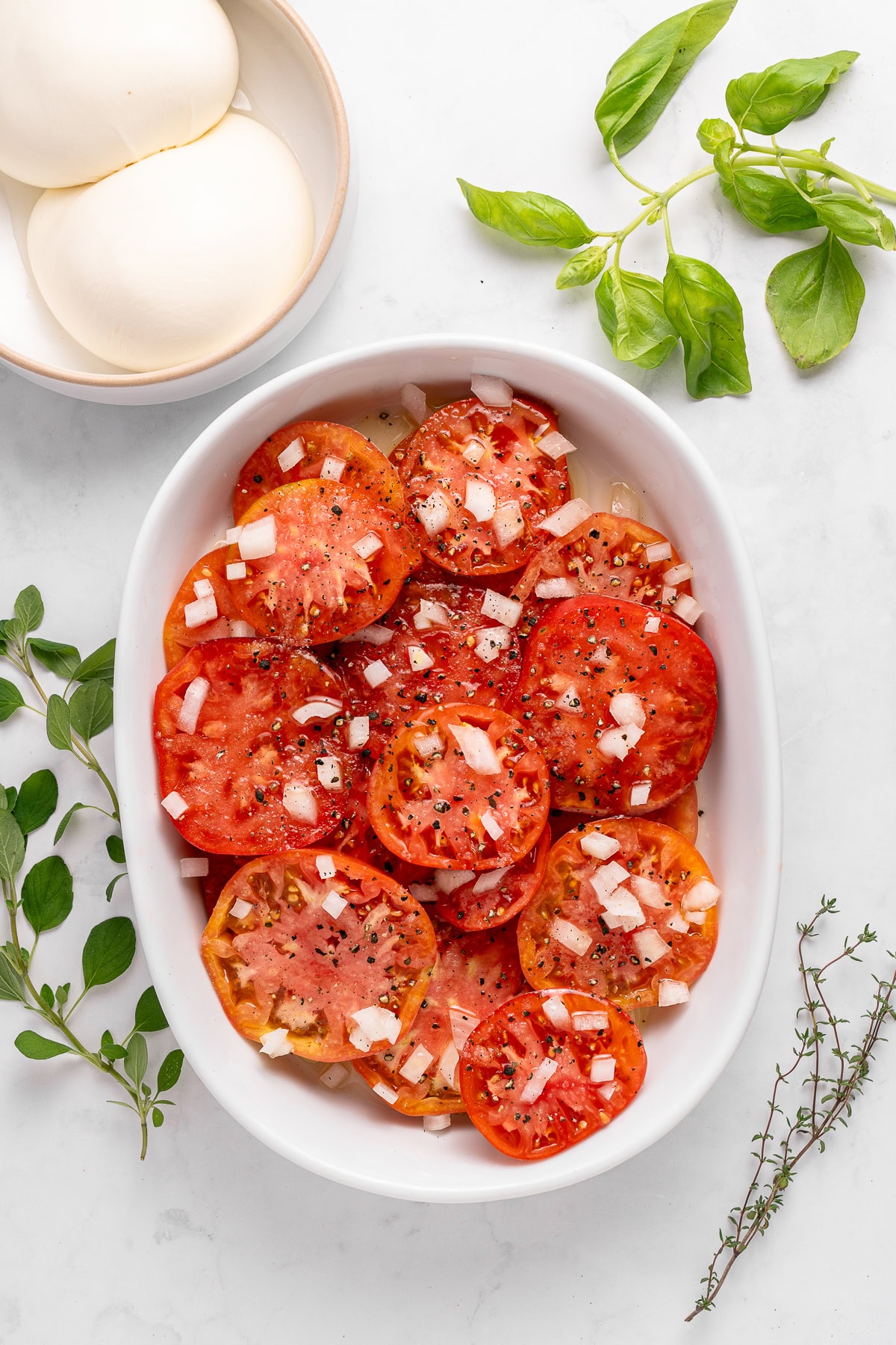A Tomato Burrata Salad like this can be a show-stopper for any get-together. Use fresh heirloom tomatoes if available. They are the best with the creamy burrata. Sliced tomatoes with diced onion.