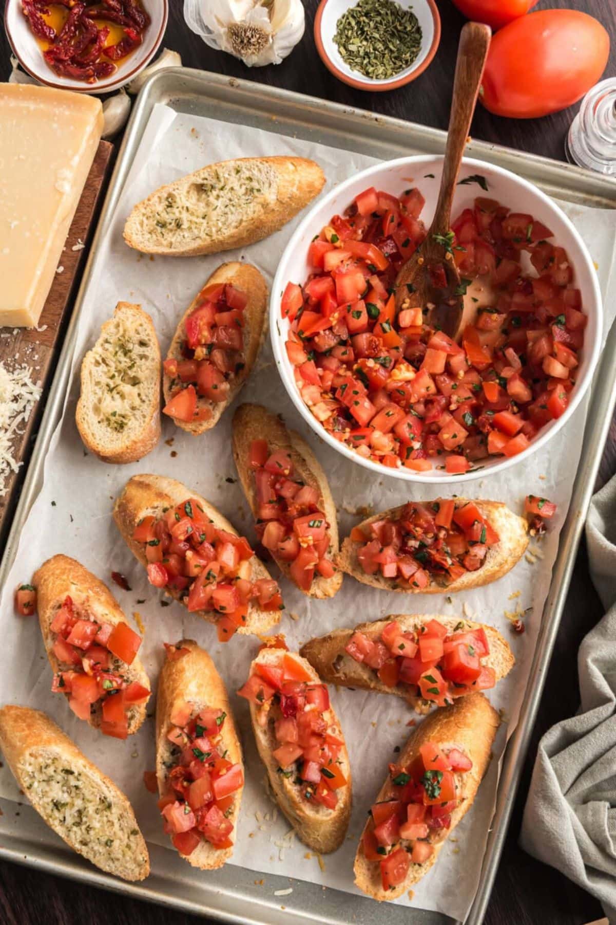 Get outside and enjoy the day with these 50 Picnic Basket Essentials. There is something for everyone to pack the perfect picnic and enjoy family time and the great outdoors. Bruschetta on a parchment lined tray.