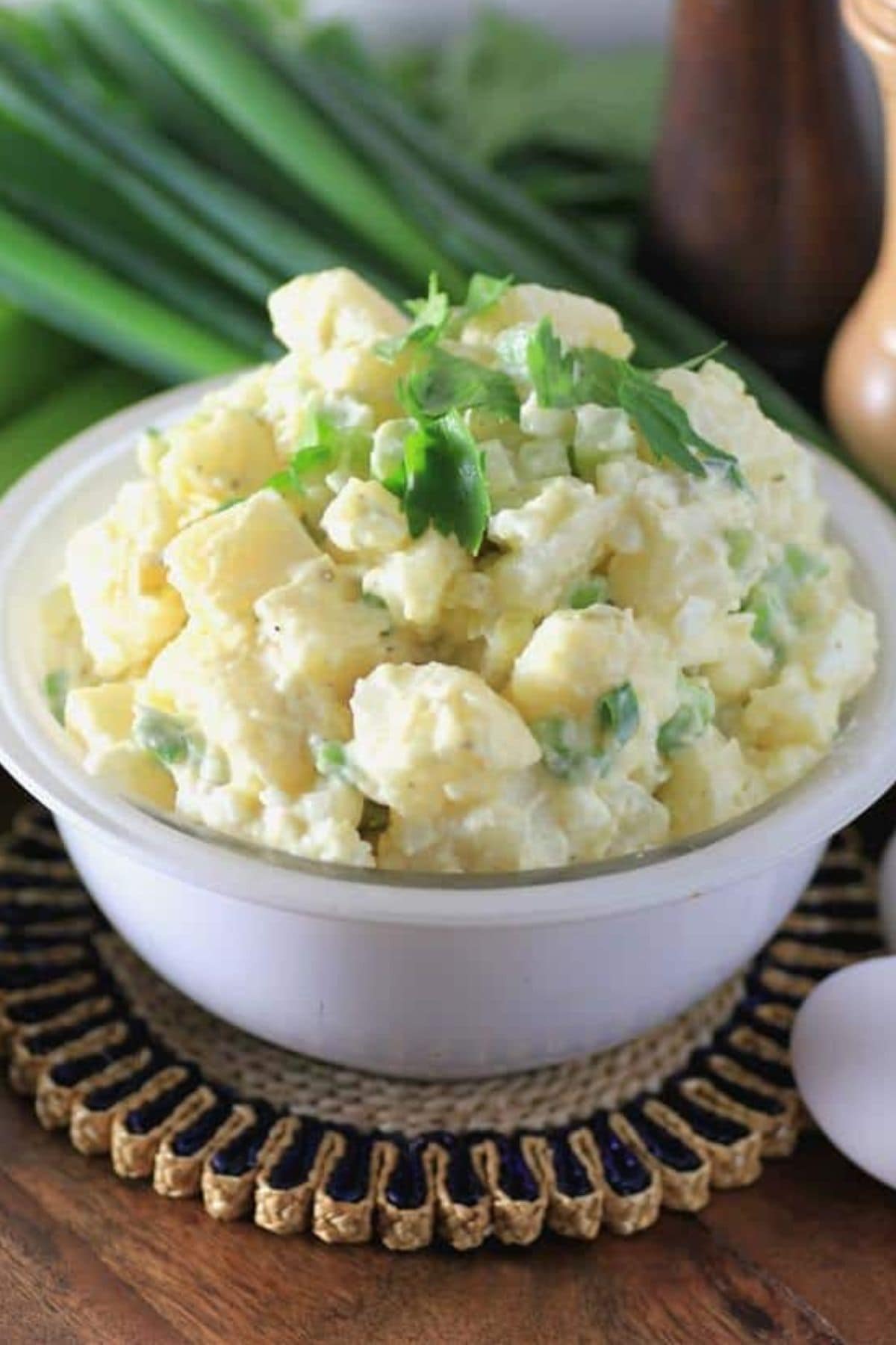 Get outside and enjoy the day with these 50 Picnic Basket Essentials. There is something for everyone to pack the perfect picnic and enjoy family time and the great outdoors. White bowl full of Grandma's potato salad.