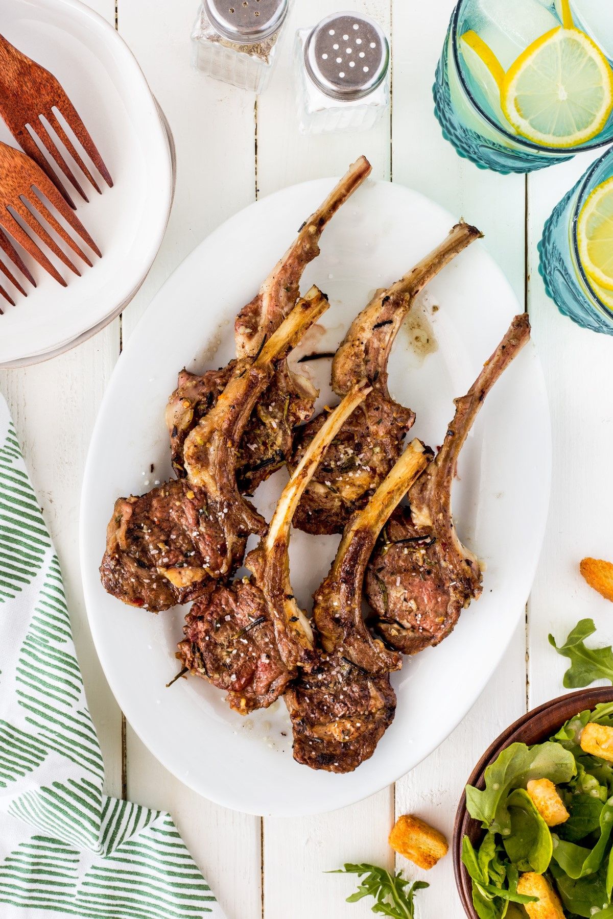 Six lamb chops on a plate.