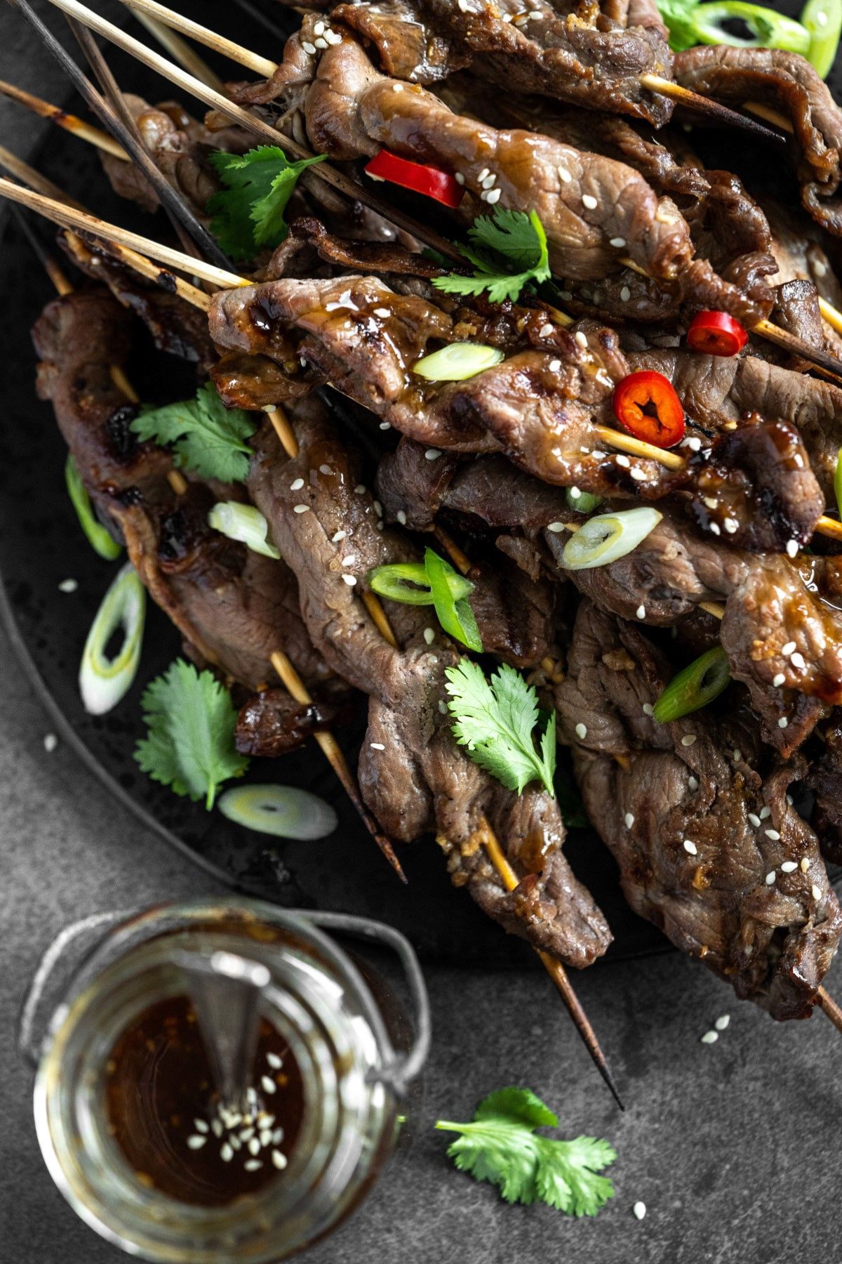 Grilled teriyaki skewers on a plate.