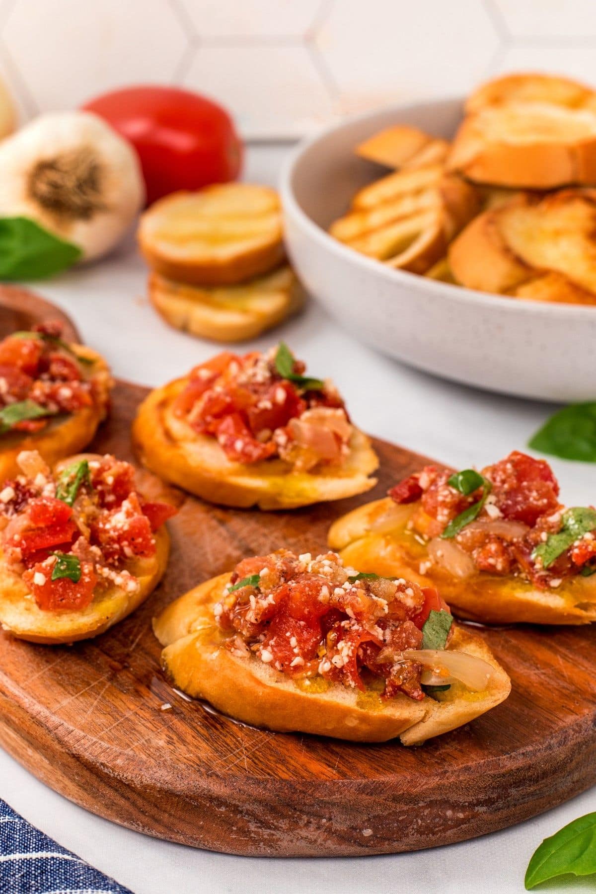 Tomato bruschetta on a wooden cutting board.