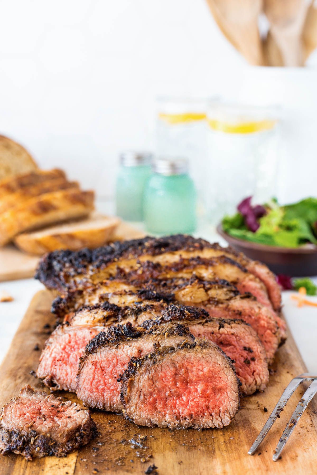 Slice tri tip on a cutting board.