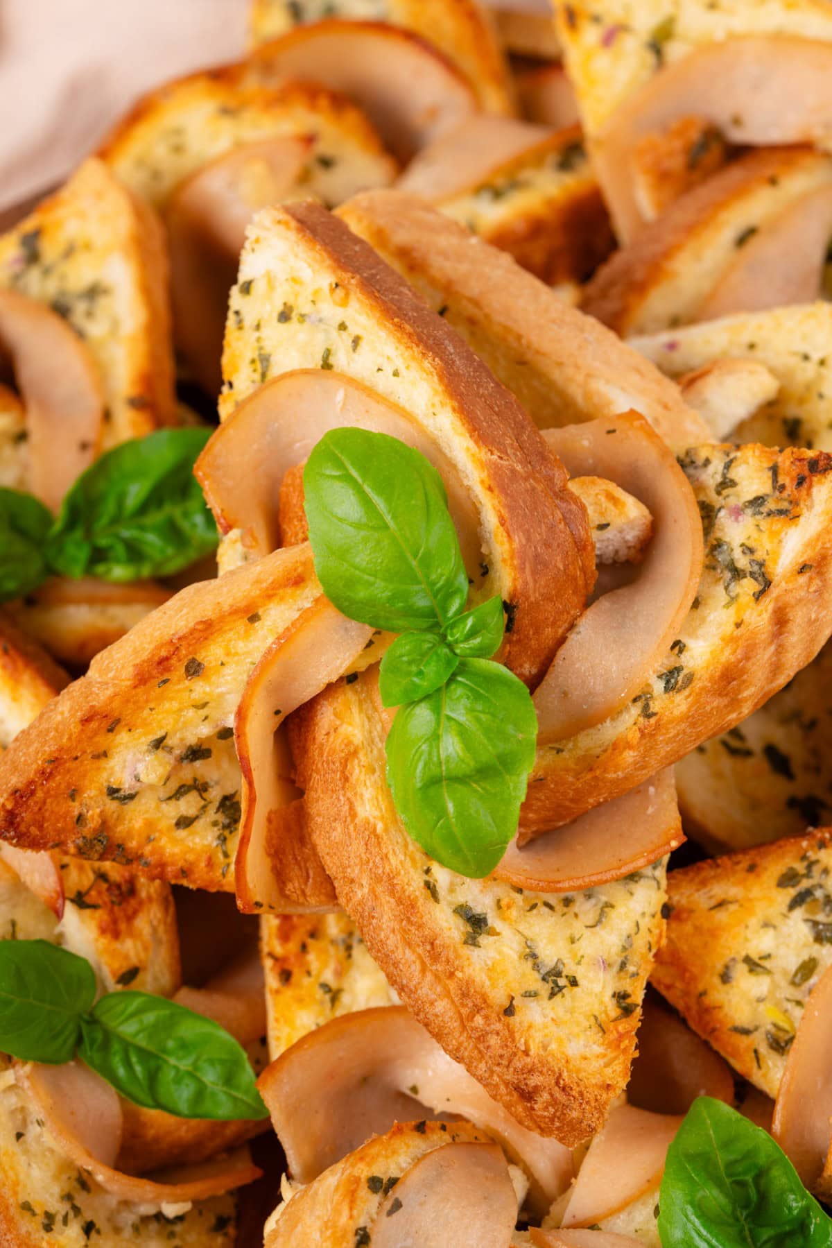 What fun are these Ham and Cheese Pinwheels, but best of all, they taste amazing. Your kids are going to ask for them all the time!! Close-up of a Ham and Cheese Pinwheel.