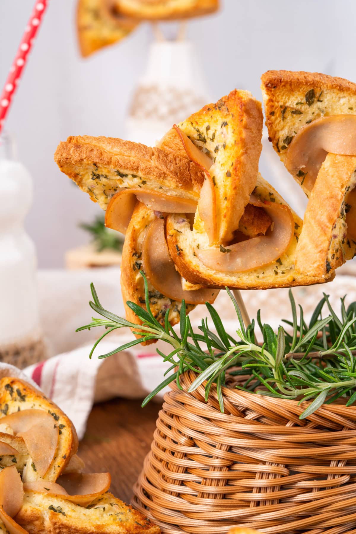 What fun are these Ham and Cheese Pinwheels, but best of all, they taste amazing. Your kids are going to ask for them all the time!! Pinwheels on a stick in a basket.
