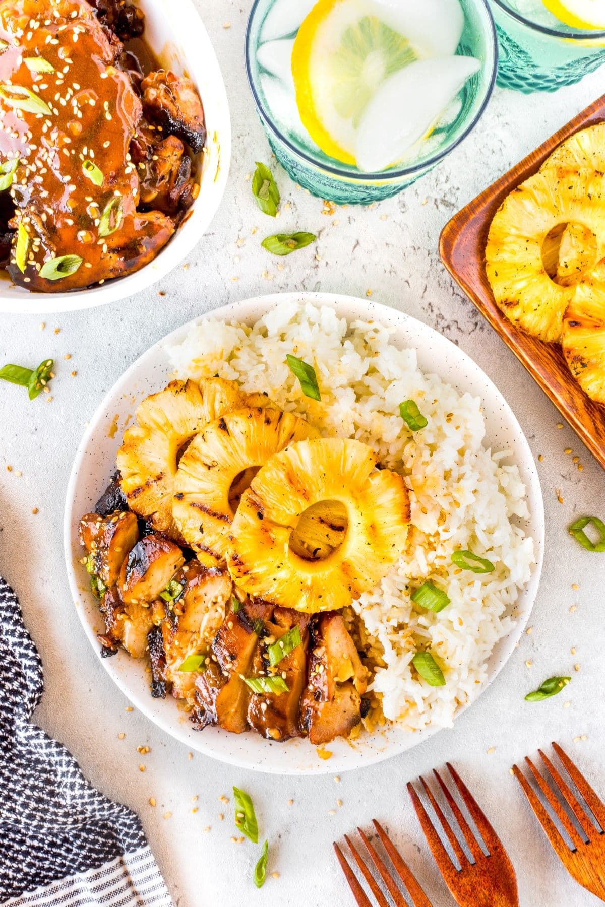 Pineapple, rice, and hawaiian chicken on a plate.