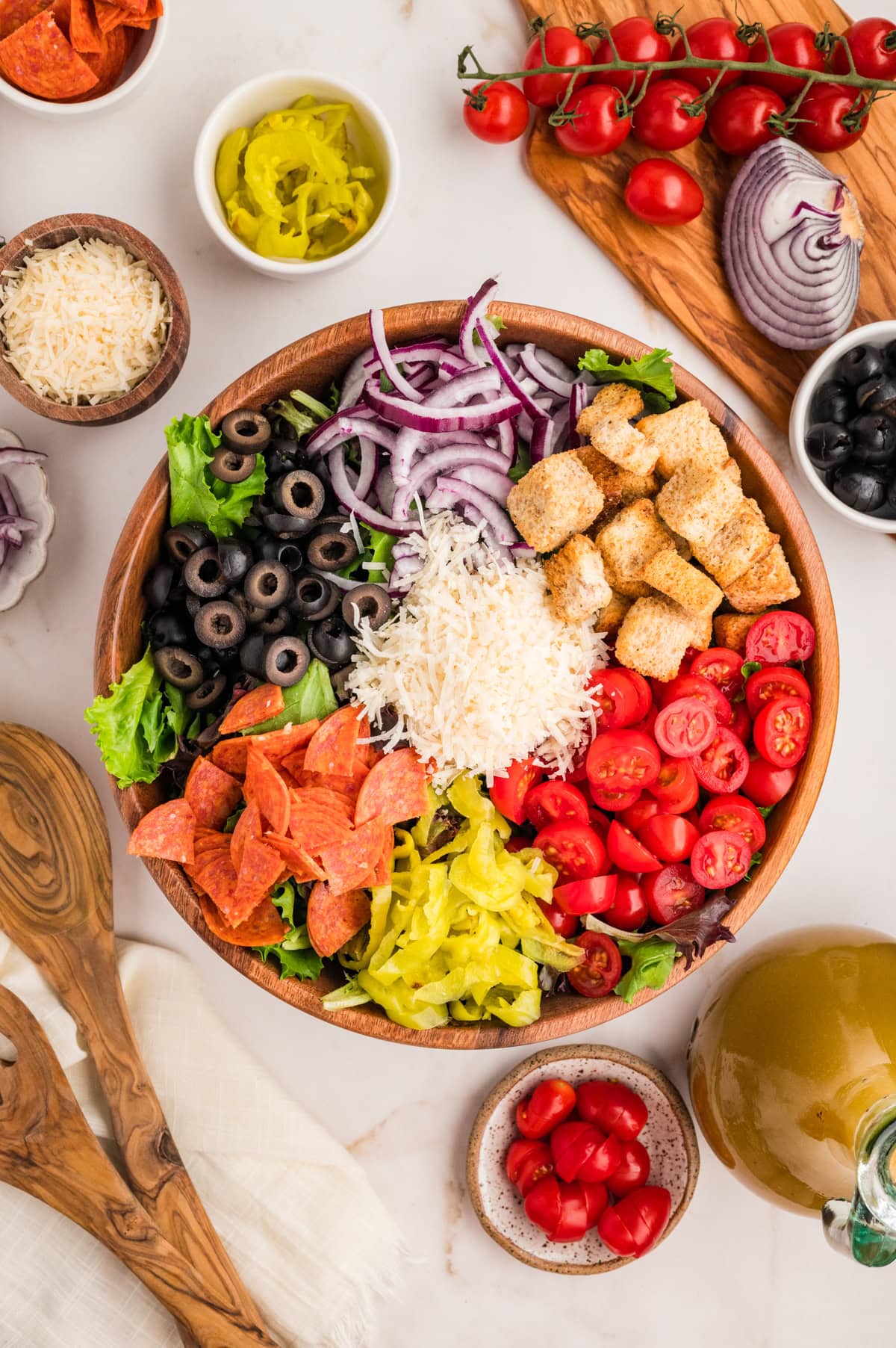 An Italian Chopped Salad adds a lot of bold flavor to any meal, but also it is healthy and delicious. This salad goes with so many mains you will want to make it again and again. Salad ingredients in a bowl.