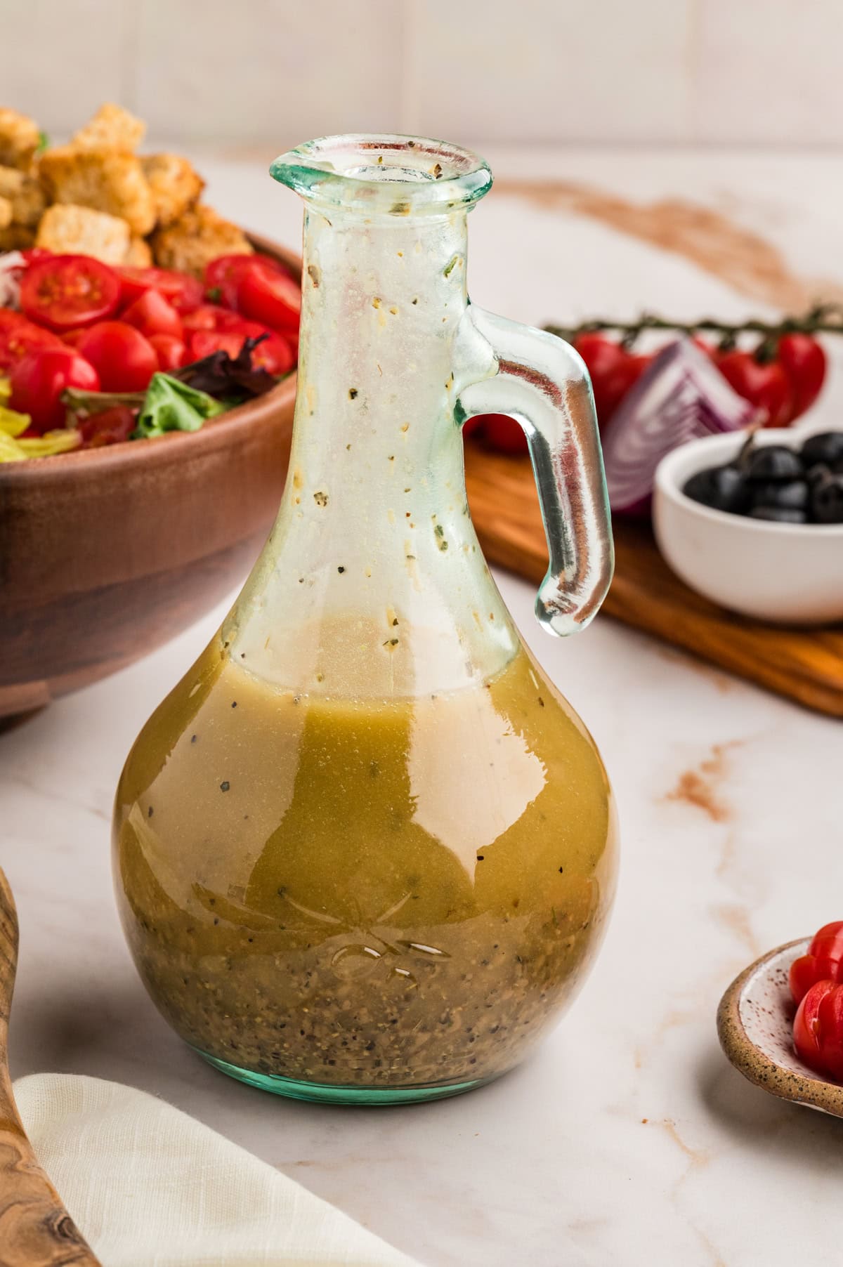An Italian Chopped Salad adds a lot of bold flavor to any meal, but also it is healthy and delicious. This salad goes with so many mains you will want to make it again and again. Dressing in a cruet.