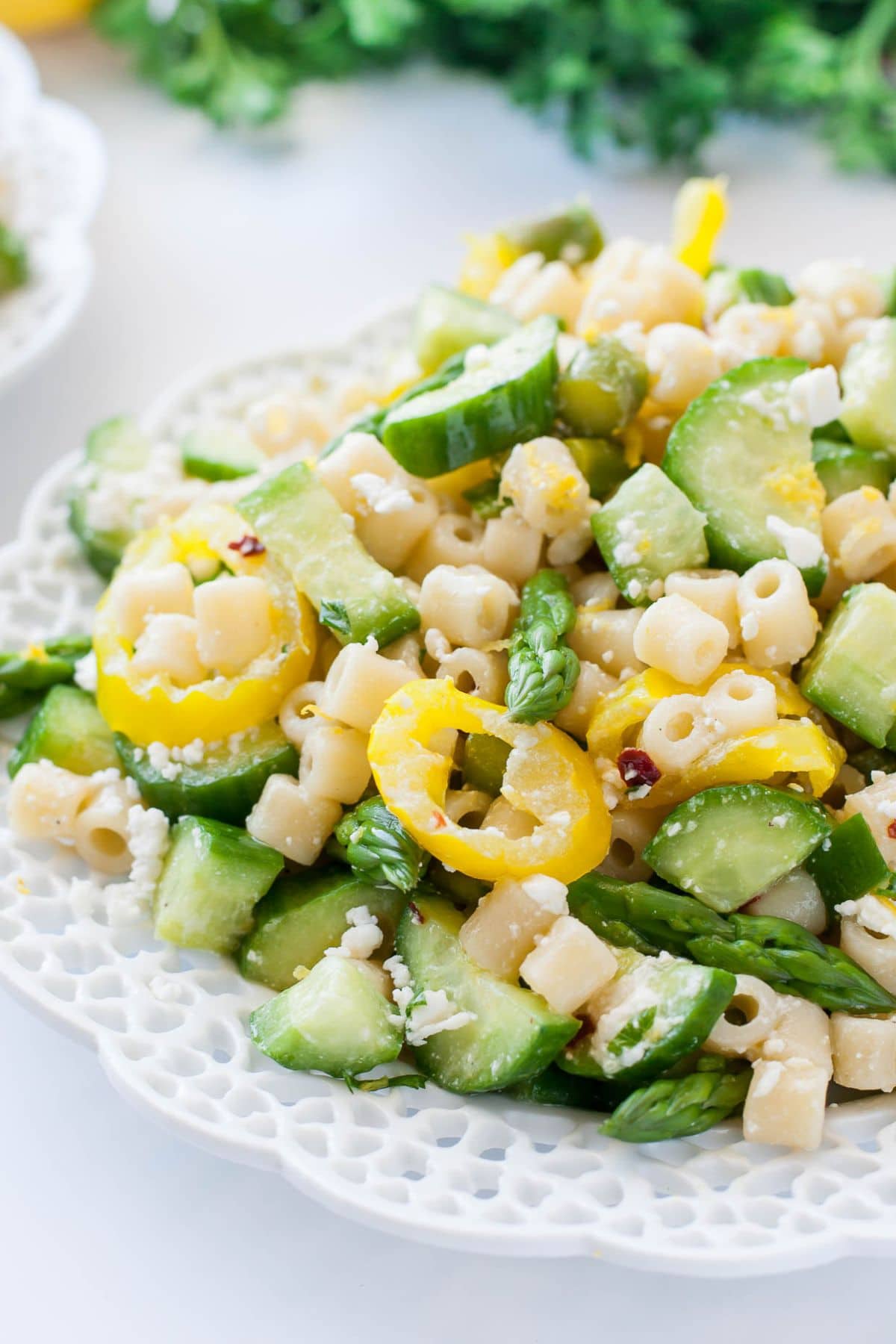 Get outside and enjoy the day with these 50 Picnic Basket Essentials. There is something for everyone to pack the perfect picnic and enjoy family time and the great outdoors. Plate full of asparagus pasta salad.