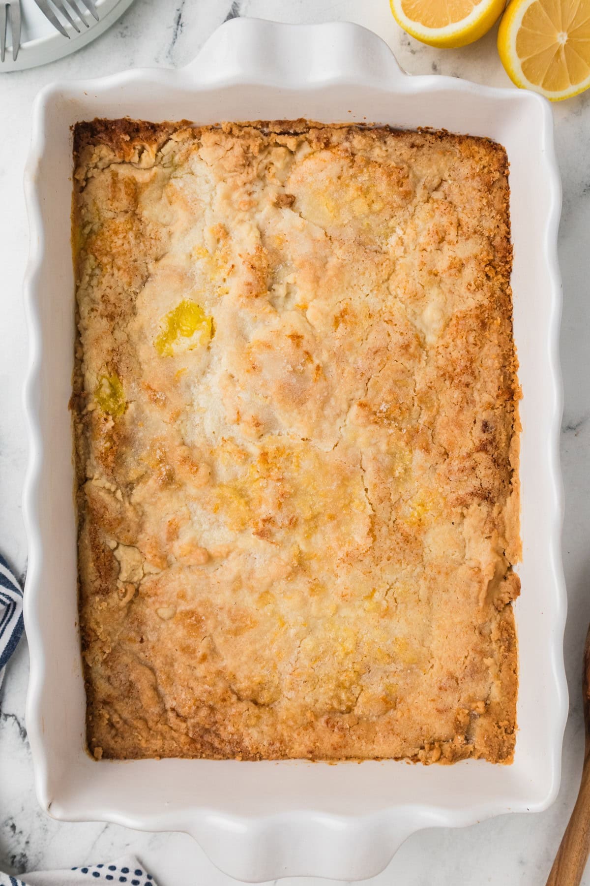 Need a quick and easy recipe? This Lemon Dump Cake is not only easy but delicious. It transports well, making a great potluck offering, and is summery and bright. Lemon lovers will be thrilled. Baked Lemon Dump Cake.