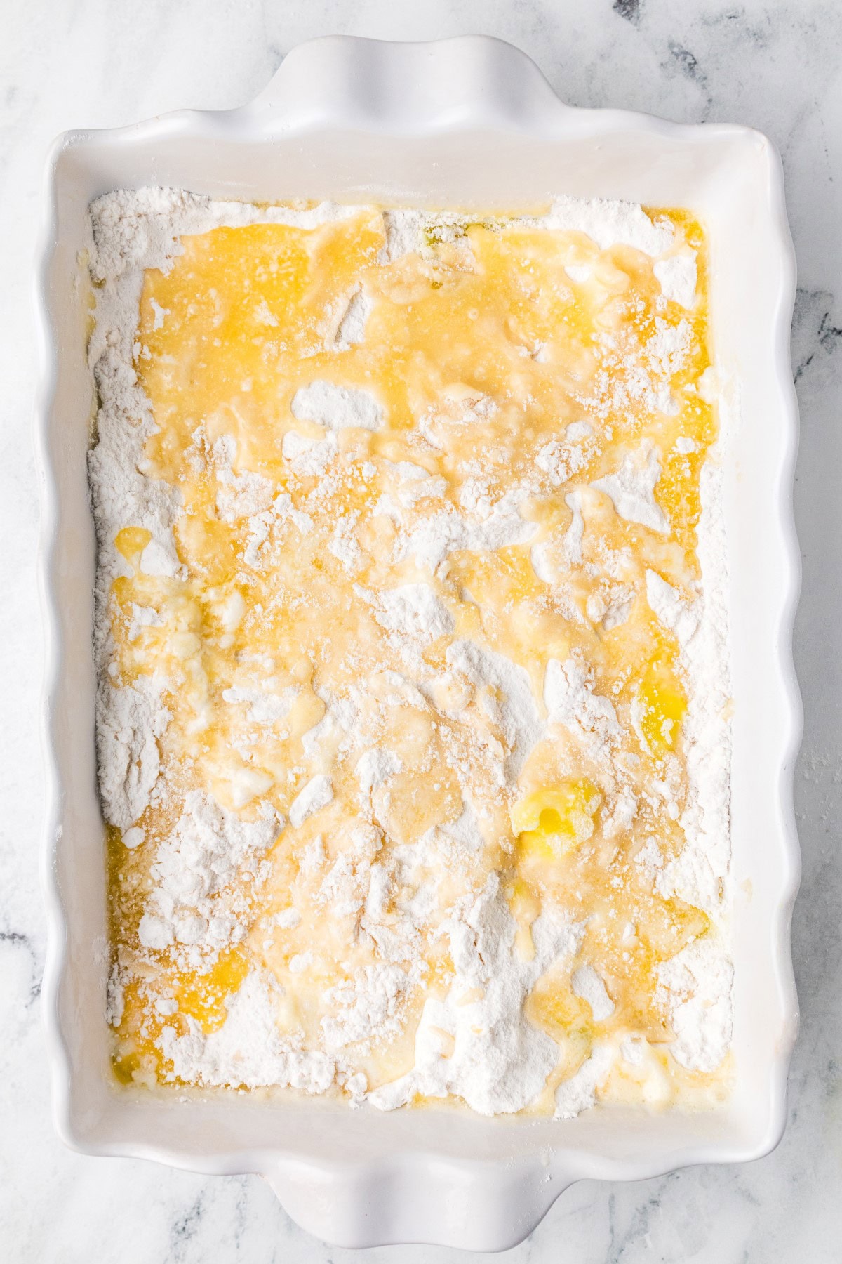 Need a quick and easy recipe? This Lemon Dump Cake is not only easy but delicious. It transports well, making a great potluck offering, and is summery and bright. Lemon lovers will be thrilled. Butter and water added.
