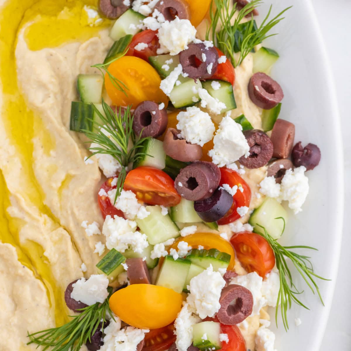 Want to up your appetizer to a healthy level without compromising flavor? Then try this amazing Loaded Hummus!! Everyone will dive into this delicious dish and you can watch it disappear. Close-up of Loaded Hummus.