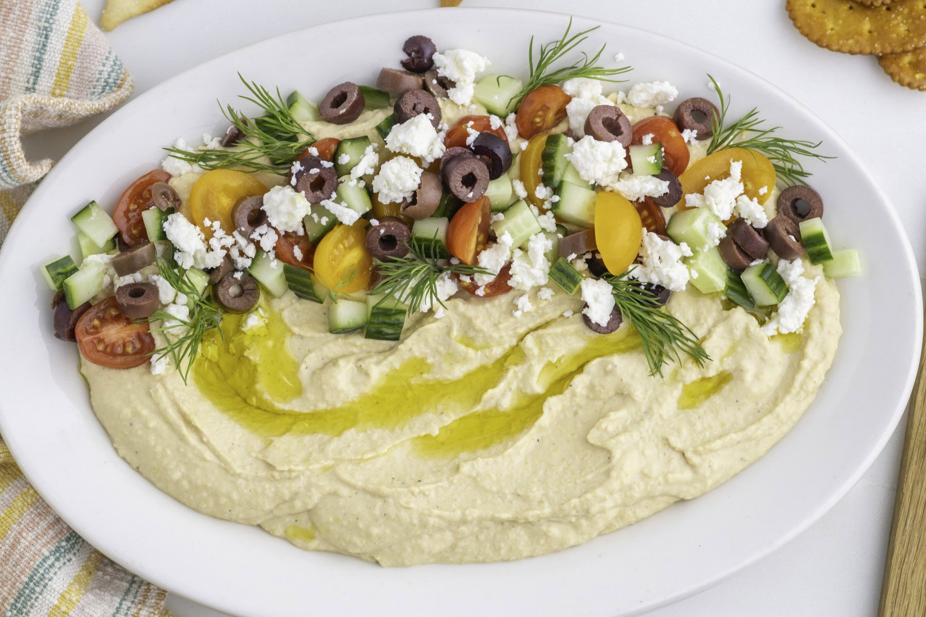 Want to up your appetizer to a healthy level without compromising flavor? Then try this amazing Loaded Hummus!! Everyone will dive into this delicious dish and you can watch it disappear. Horizontal served up on a platter.