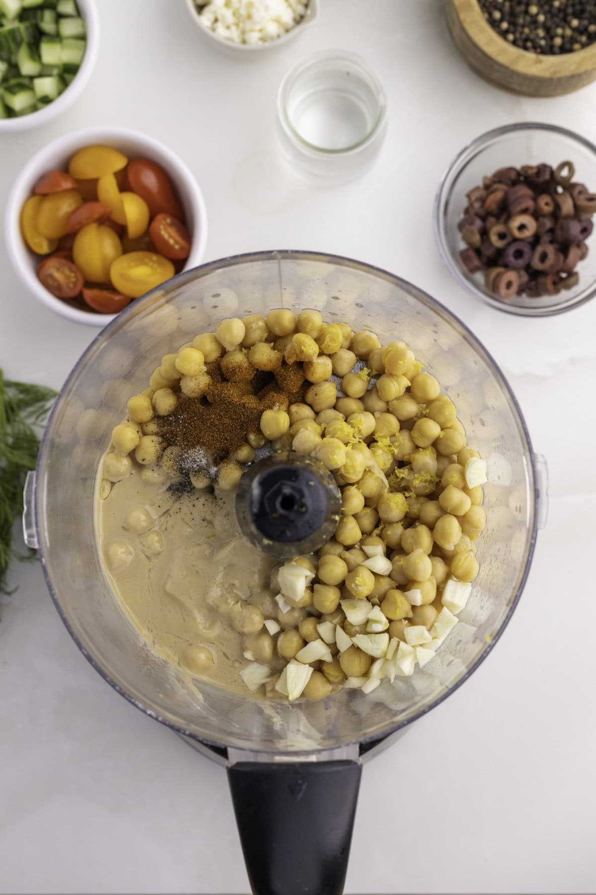 Want to up your appetizer to a healthy level without compromising flavor? Then try this amazing Loaded Hummus!! Everyone will dive into this delicious dish and you can watch it disappear. Hummus ingredients in a food processor.