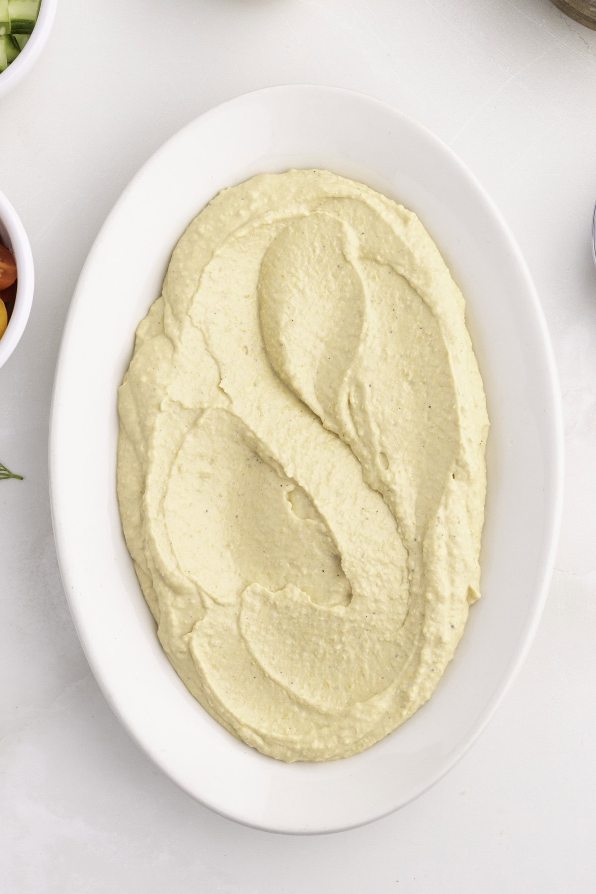 Want to up your appetizer to a healthy level without compromising flavor? Then try this amazing Loaded Hummus!! Everyone will dive into this delicious dish and you can watch it disappear. Hummus on a platter.