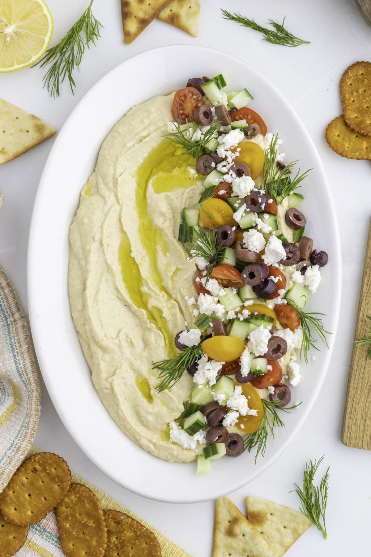 Want to up your appetizer to a healthy level without compromising flavor? Then try this amazing Loaded Hummus!! Everyone will dive into this delicious dish and you can watch it disappear. Loaded Hummus on a platter.