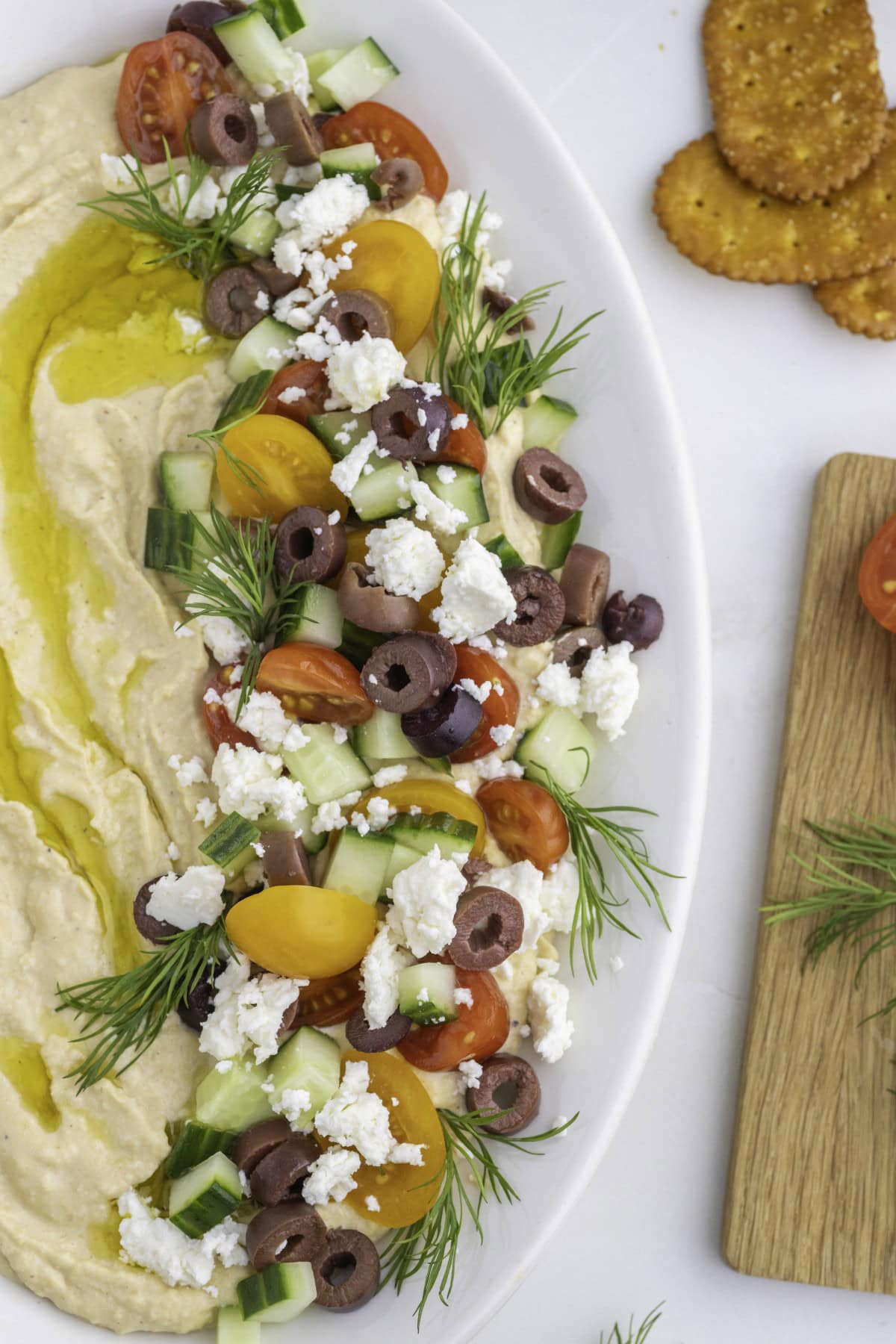 Want to up your appetizer to a healthy level without compromising flavor? Then try this amazing Loaded Hummus!! Everyone will dive into this delicious dish and you can watch it disappear. Overhead of a portion of Loaded Hummus.