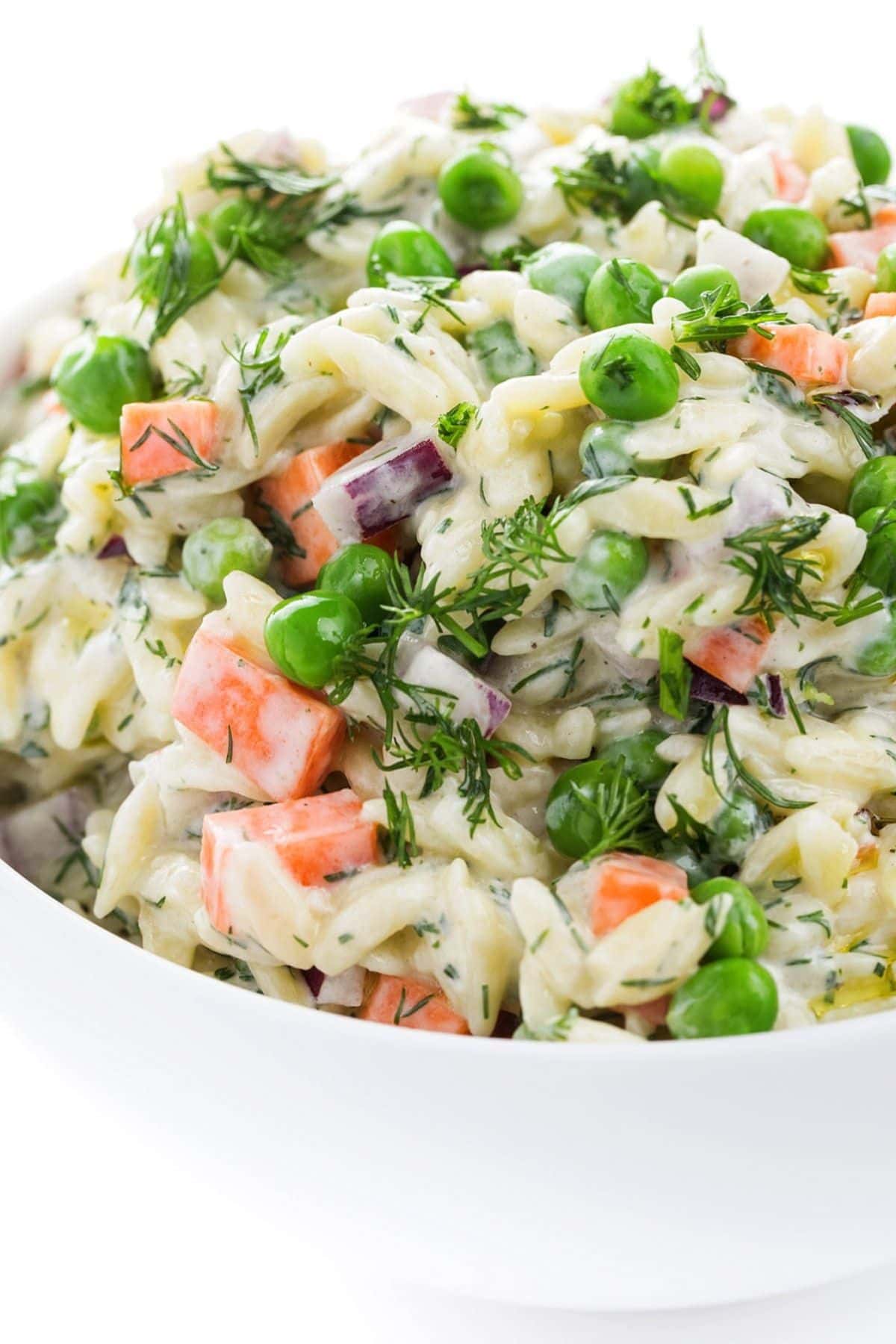Get outside and enjoy the day with these 50 Picnic Basket Essentials. There is something for everyone to pack the perfect picnic and enjoy family time and the great outdoors. White bowl full of orzo salad.