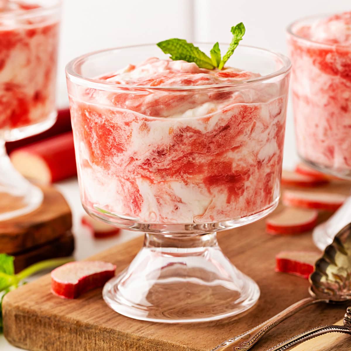 A delightful Rhubarb Fool is easy to make yet offers an elegant dessert. It is perfect after a BBQ in the spring and summer, as it is light as a cloud. Front view of Rhubarb Fool in a desert glass.