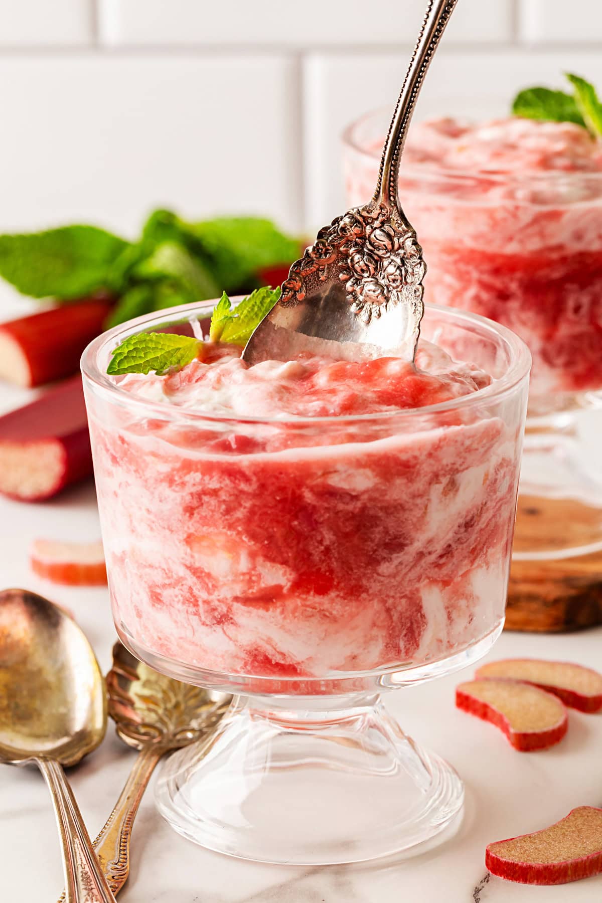 A delightful Rhubarb Fool is easy to make yet offers an elegant dessert. It is perfect after a BBQ in the spring and summer, as it is light as a cloud. Taking a spoonful.