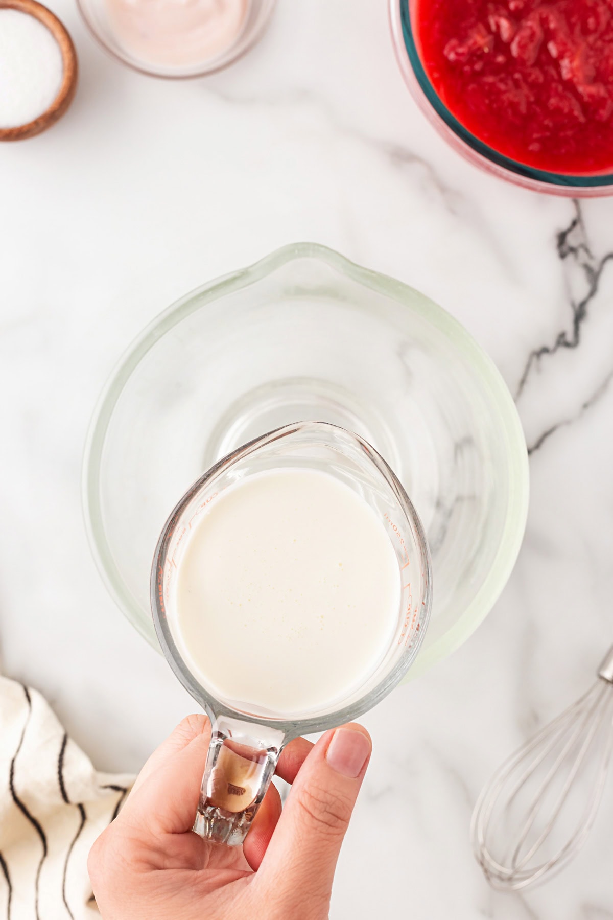 A delightful Rhubarb Fool is easy to make yet offers an elegant dessert. It is perfect after a BBQ in the spring and summer, as it is light as a cloud. Whipping cream in a measuring cup.