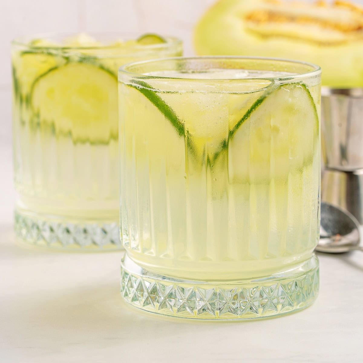 Vodka Cucumber Cocktail is the perfect summer porch sipper on a hot day!! It is easy enough to make for yourself, but perfect for any gathering or BBQ! Your company will rave over it. Close-up of a cocktail.