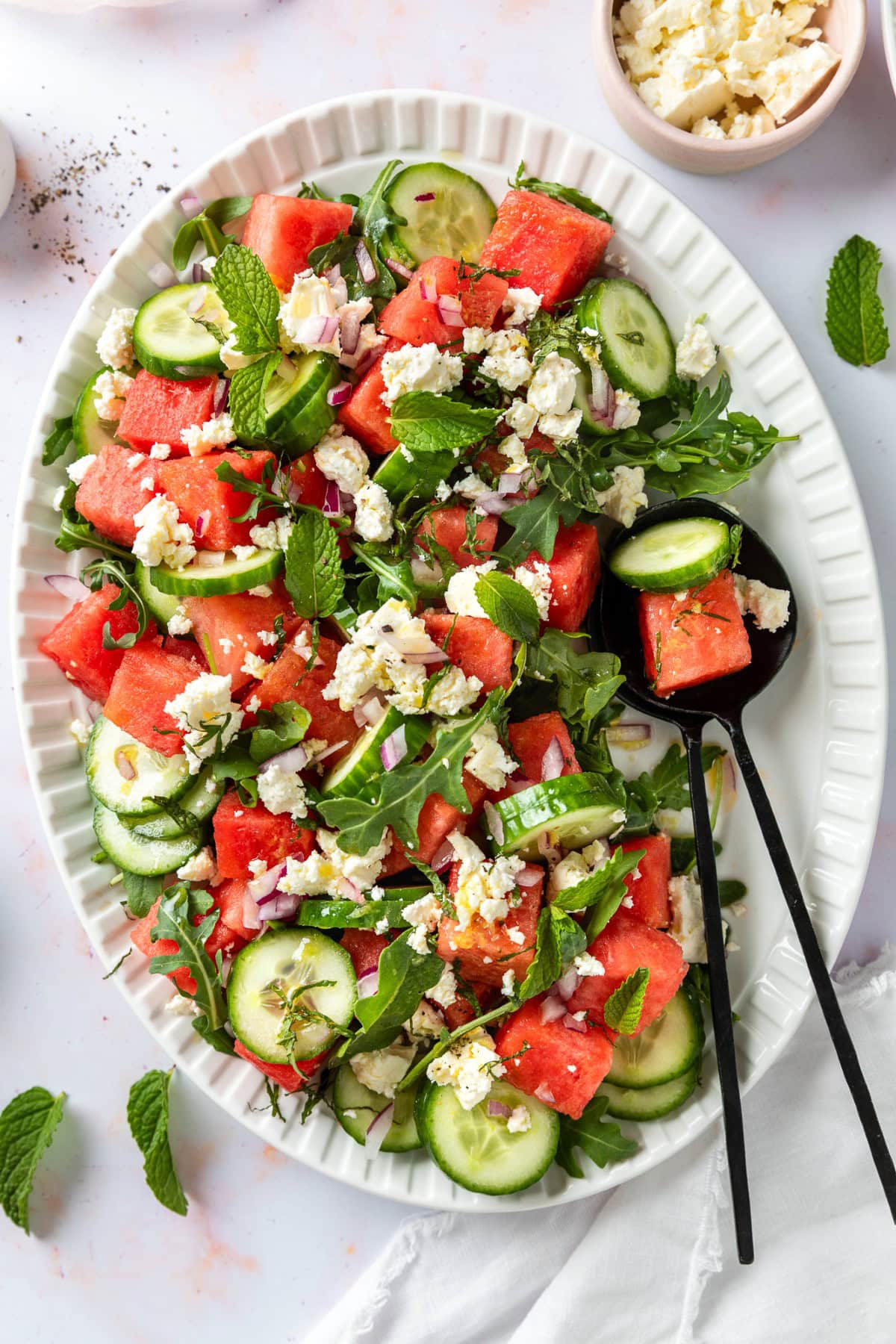 Starting to serve the salad. 