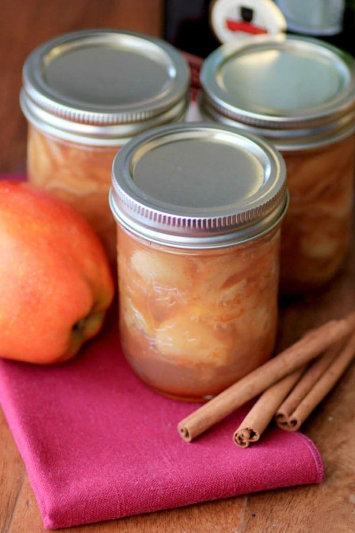 Jar filled with brandied apple preserves.