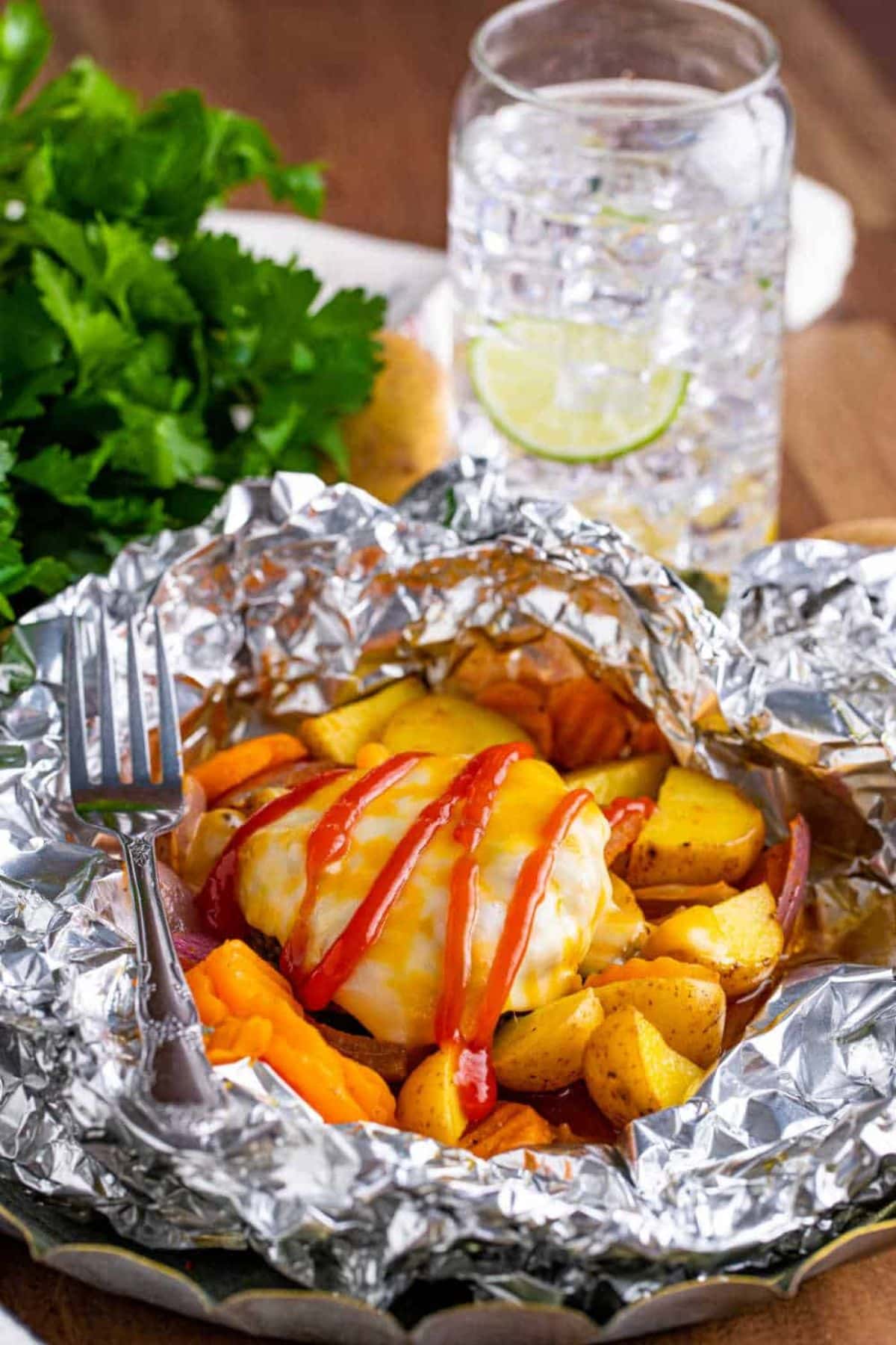 Are you enjoying the great outdoors this summer and wondering what to eat? Try some of these 20 Awesome Campfire Recipes!! Burger patty and potatoes in foil.