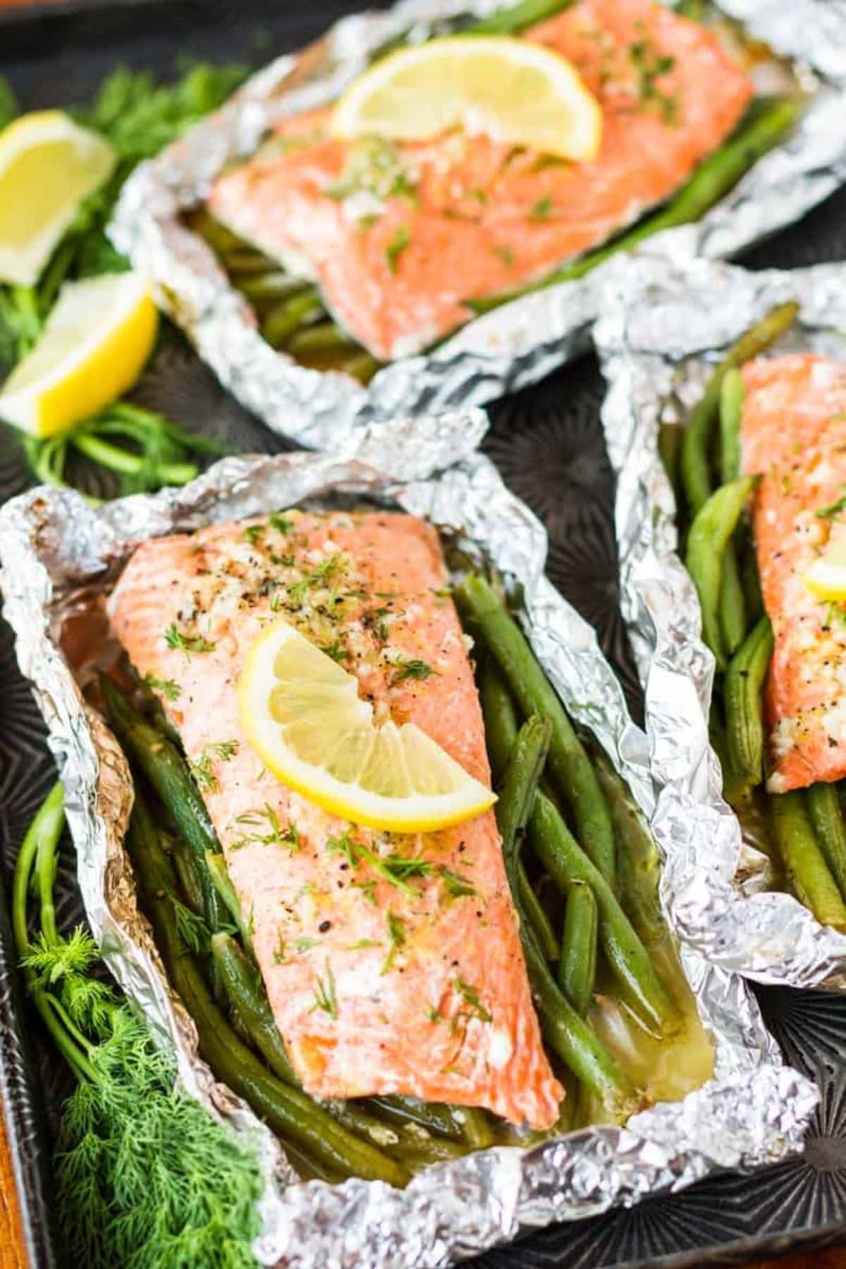 Are you enjoying the great outdoors this summer and wondering what to eat? Try some of these 20 Awesome Campfire Recipes!! Salmon and asparagus in foil.