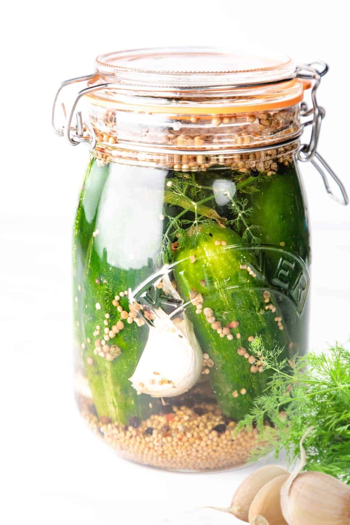 Resealable jar full of pickles.