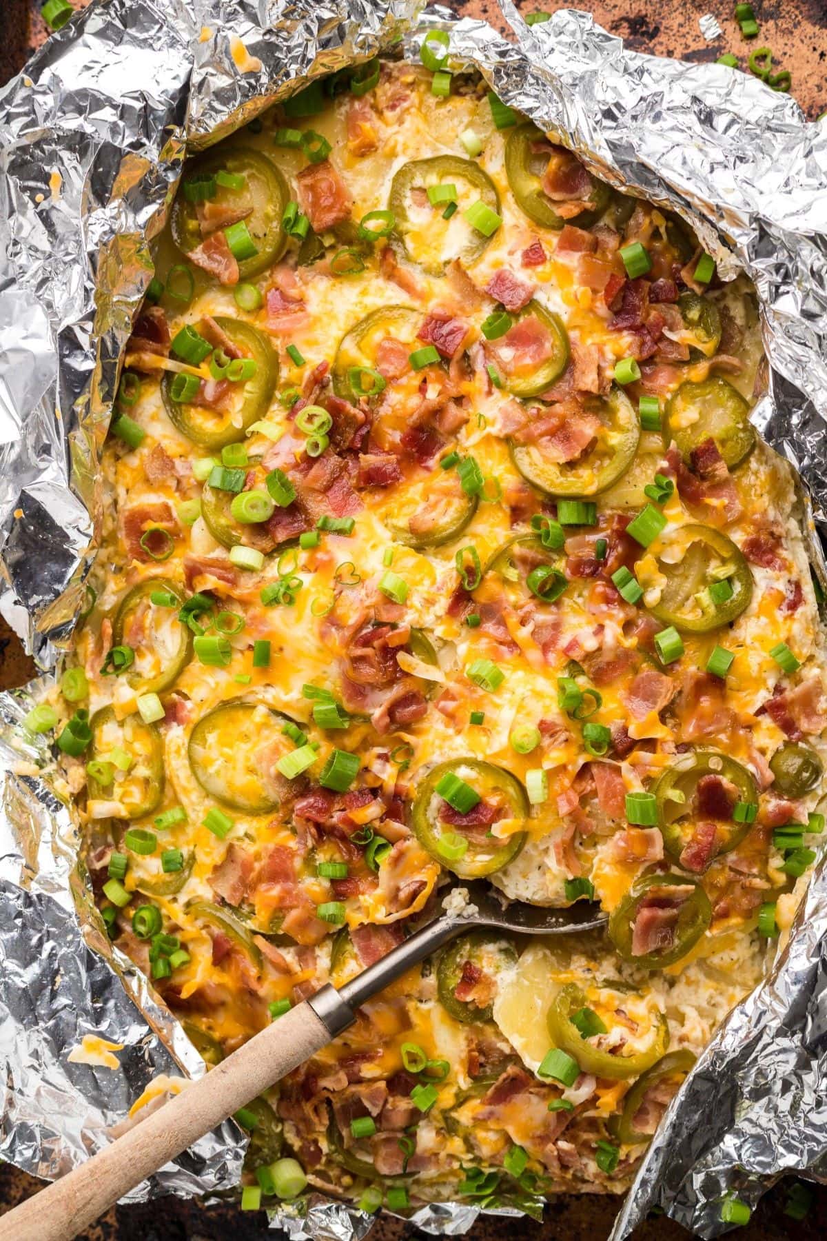 Are you enjoying the great outdoors this summer and wondering what to eat? Try some of these 20 Awesome Campfire Recipes!! Potatoes and jalapenos in a foil pack.
