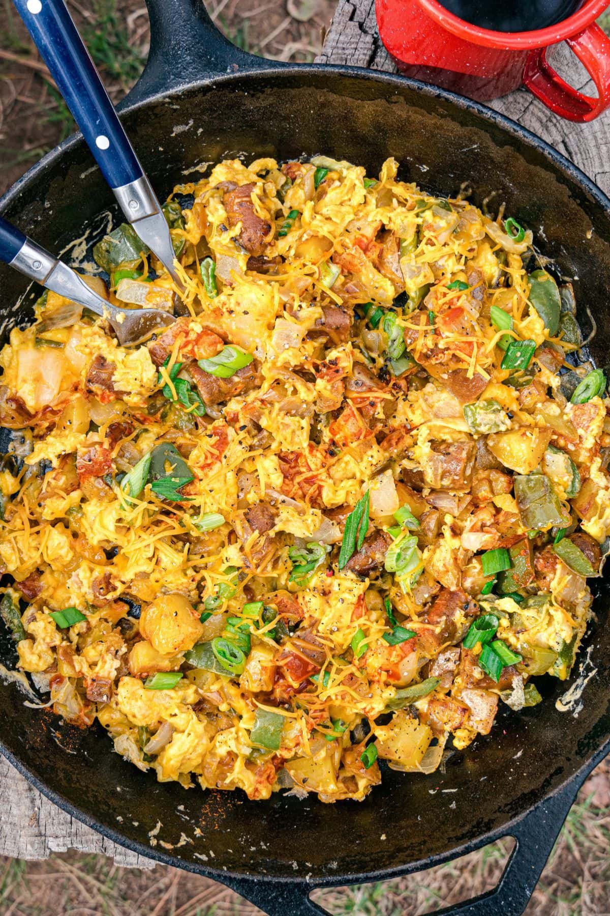 Are you enjoying the great outdoors this summer and wondering what to eat? Try some of these 20 Awesome Campfire Recipes!! Potatoes and bacon in cast iron skillet.