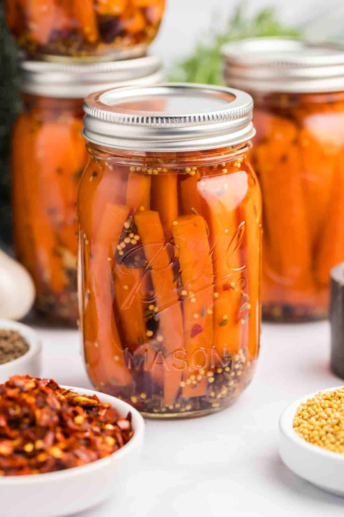 Pint jar full of pickled carrots.