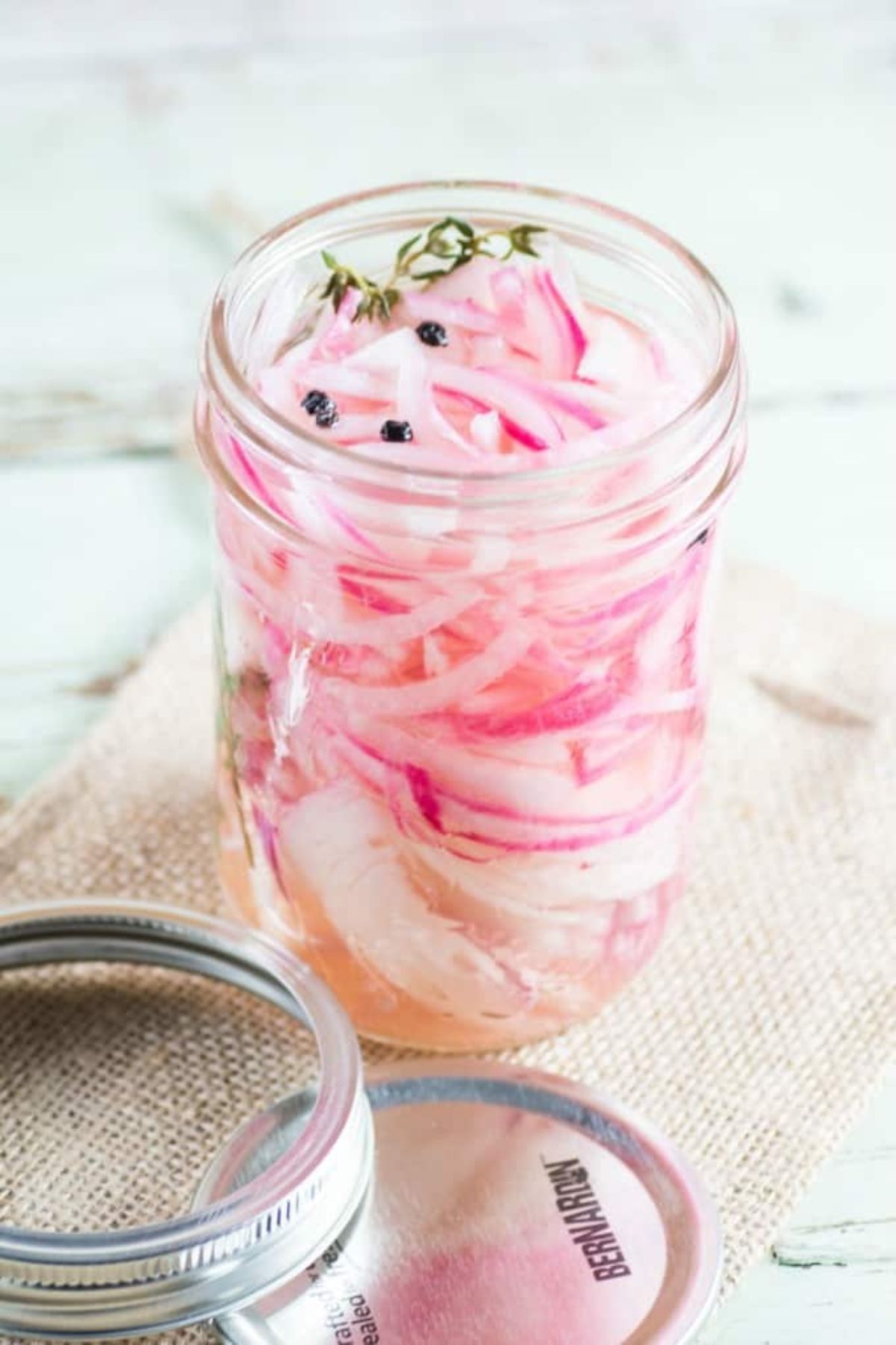Pint jar full of pickled onions.