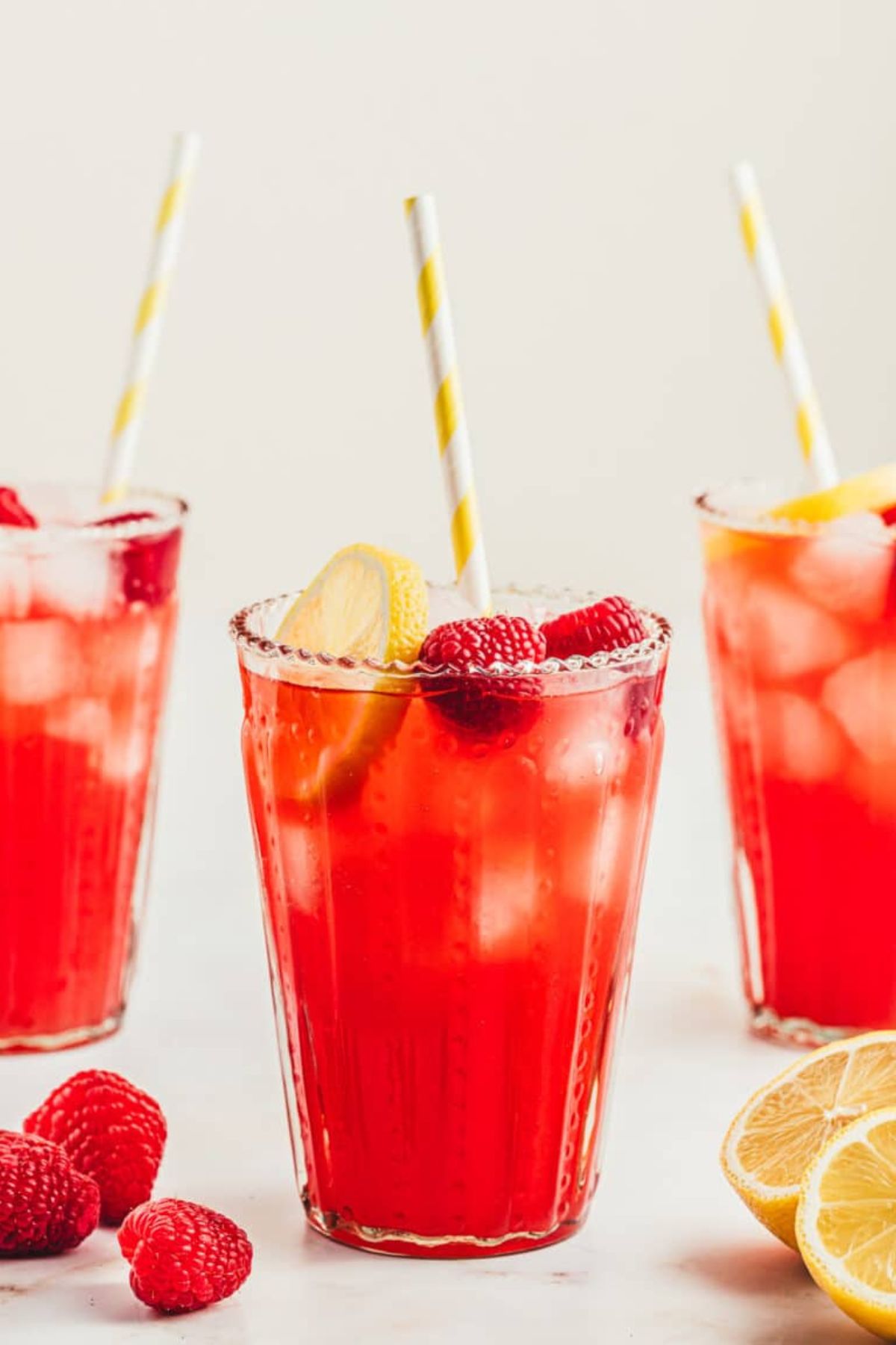 Get outside and enjoy the day with these 50 Picnic Basket Essentials. There is something for everyone to pack the perfect picnic and enjoy family time and the great outdoors. Glass full of raspberry lemonade.